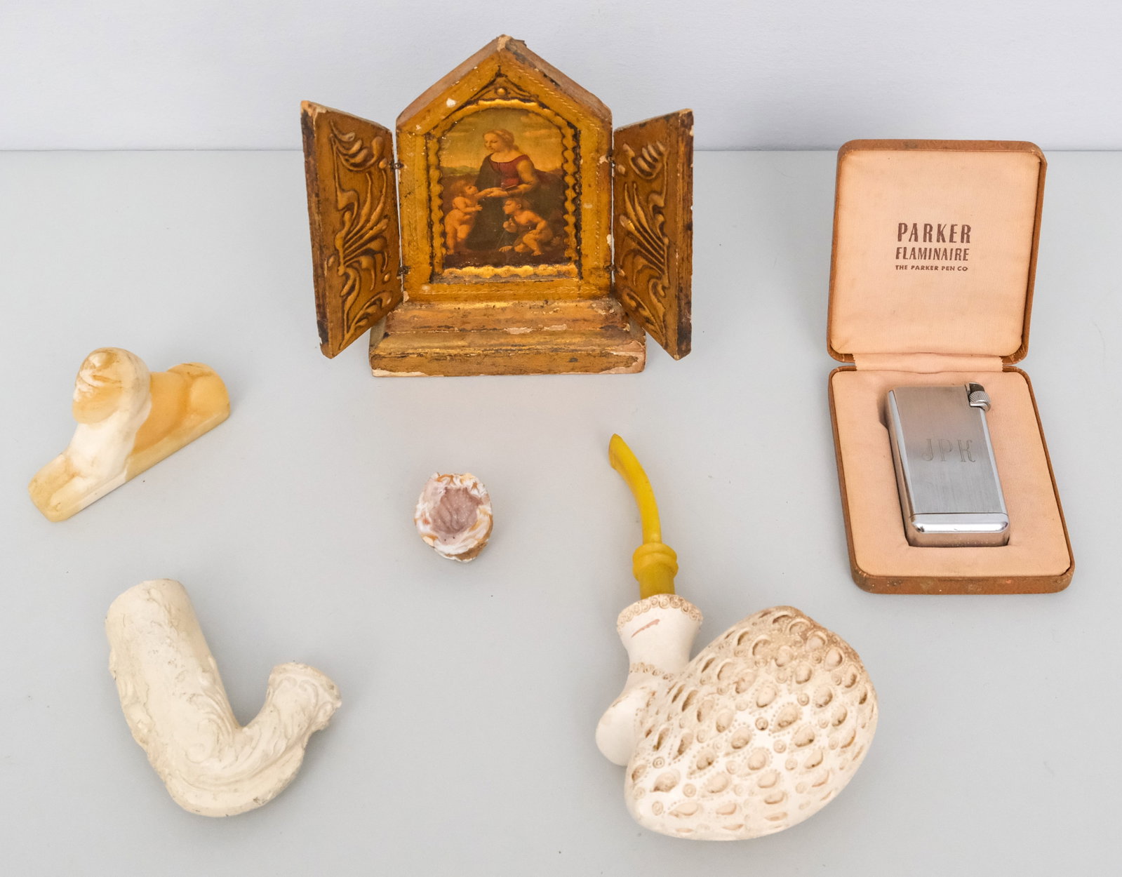 Intriguing Group of Bureau Discovered Objects: Including two meerschaum pipes and a Parker lighter.