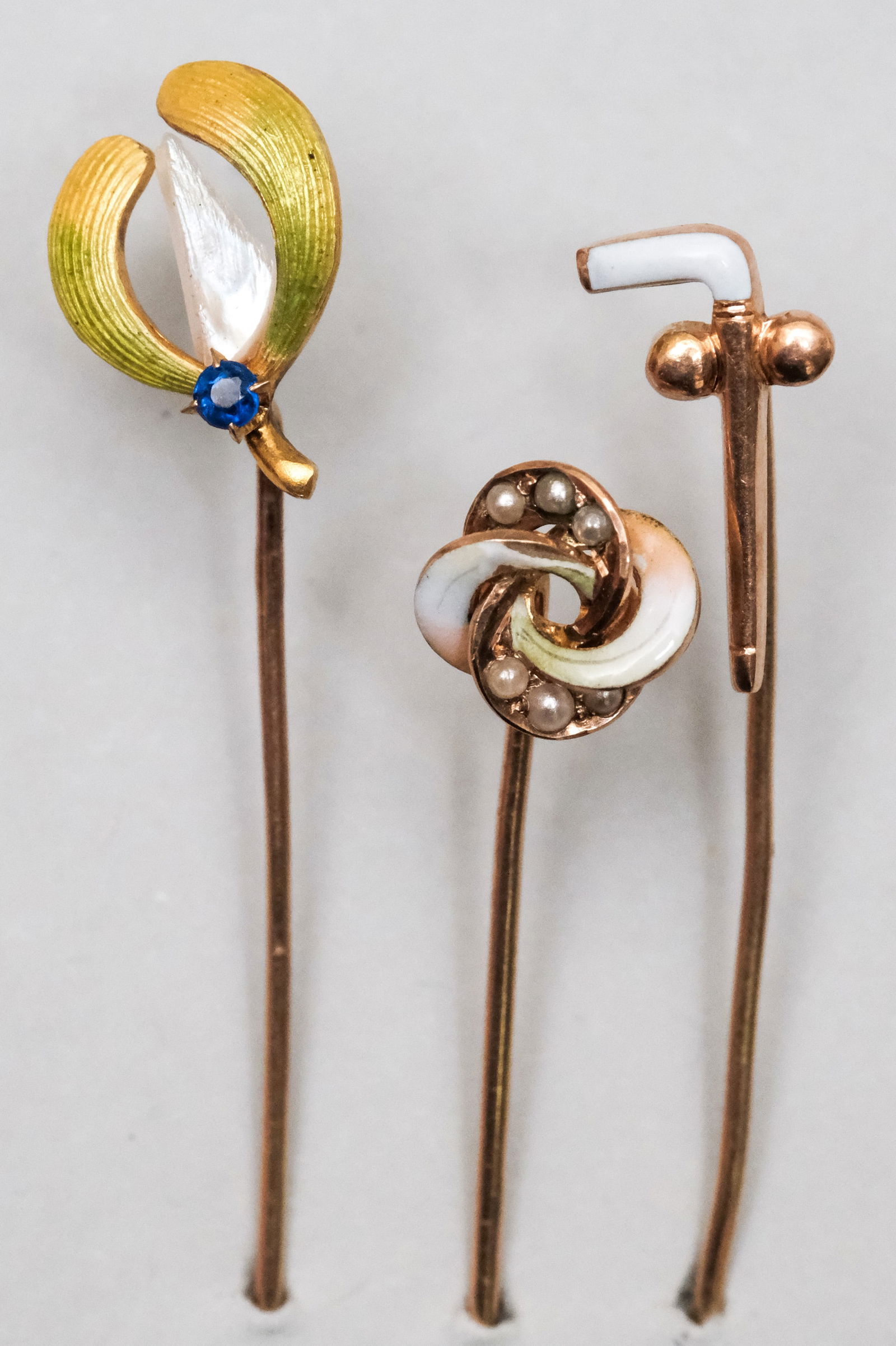 3 Antique 10K Gold & Pearl Stickpins: With enamel and dogtooth pearl examples. 1.3 dwt combined weight.