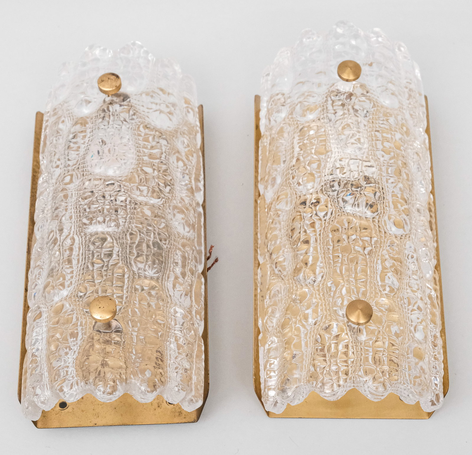 Pair Fagerland for Orrefors Lighting Fixtures: Pair of sconces in brass and textured ice glass, designed by Carl Fagerlund for Orrefors and Lyfa. Unlabeled. 5" x 11".
