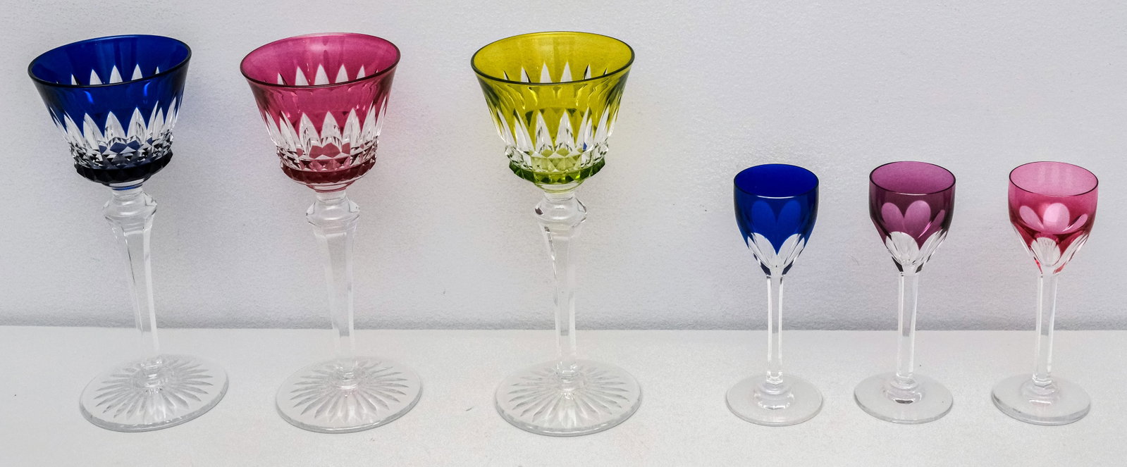 Baccarat Colored Crystal Stemware: Comprising (3) Rhine wine glasses in Buckingham and (3) cordials in Genova. Rhine 7 3/4".
