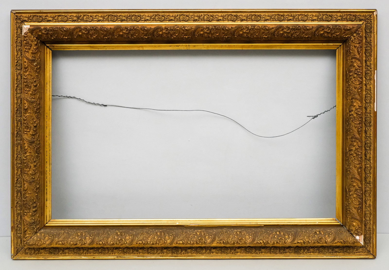 Hudson River School Gilt Frame 18" x 30": American, ca. 1880, having cushion profile with floral motif. Overall 26" x 37 1/2", rabbet 18" x 30", molding 4 1/4".