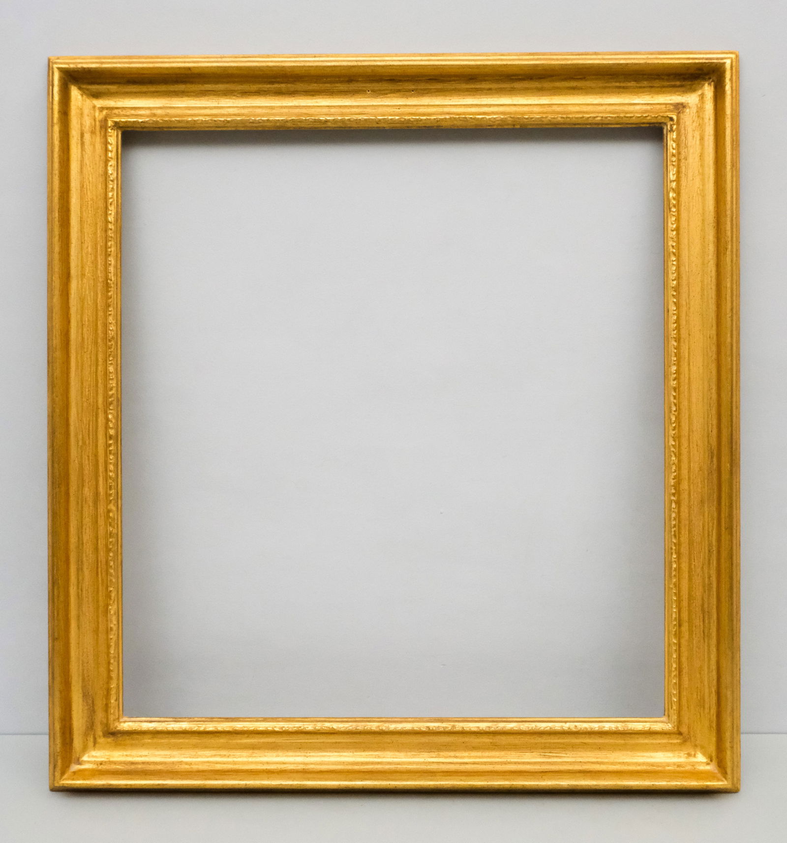 Newcomb Macklin Gilt Frame 24" x 26": Newcomb Macklin, ca. 1930, having cove profile with carved ornament at sight edge. Overall 30" x 32 1/4", rabbet 24" x 26", molding 3 1/4".
