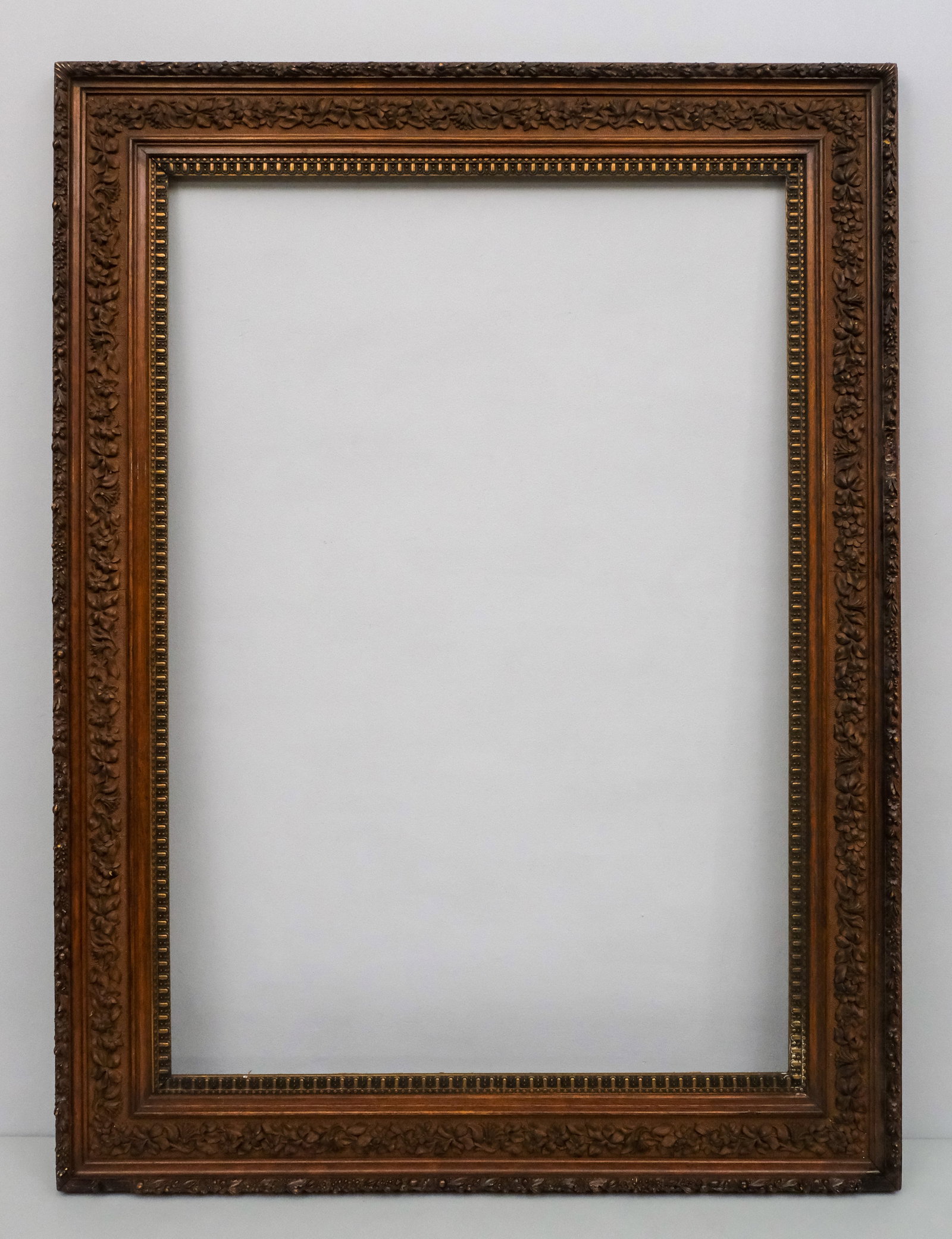 Large Aesthetic Movement Frame 29" x 42": American, ca. 1880, having flat panel profile with floral motif. Overall 39" x 52", rabbet 29" x 42", molding 5".