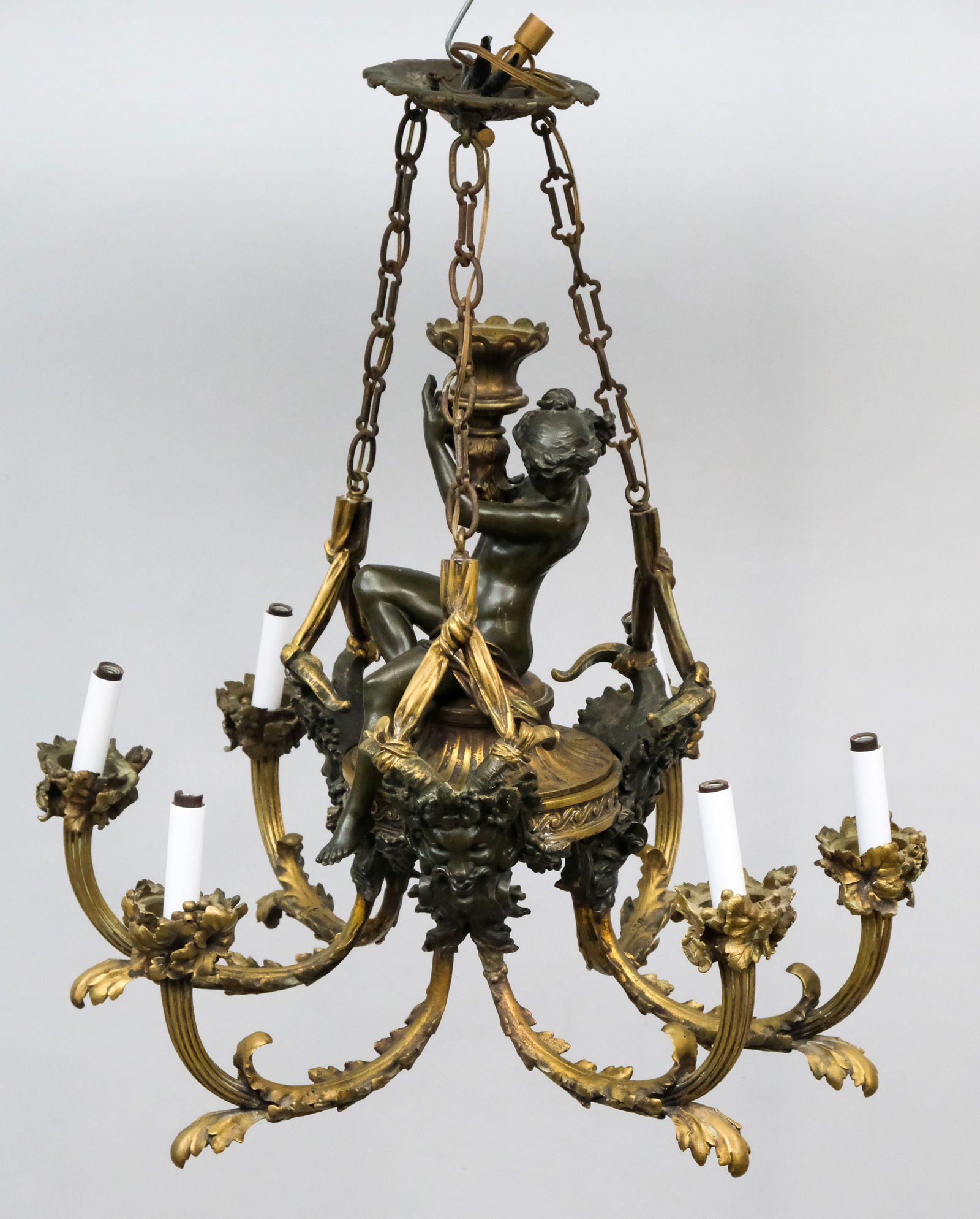 Antique Brass Empire Chandelier: 19th century brass Empire figural chandelier with bronze female nude holding aloft a goblet, 18" H x 25" diameter, 57lbs gross weight.