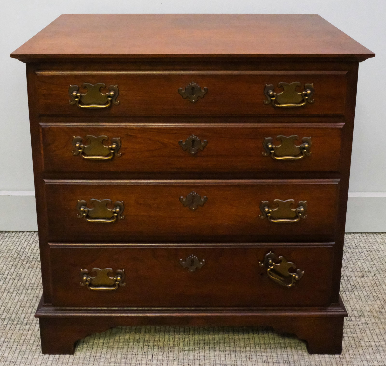 Chippendale Chest of Drawers: Early 20th century Chippendale chest of four drawers, with brass handles, 24 1/4" H x 23 3/4" W x 14 1/4" L.