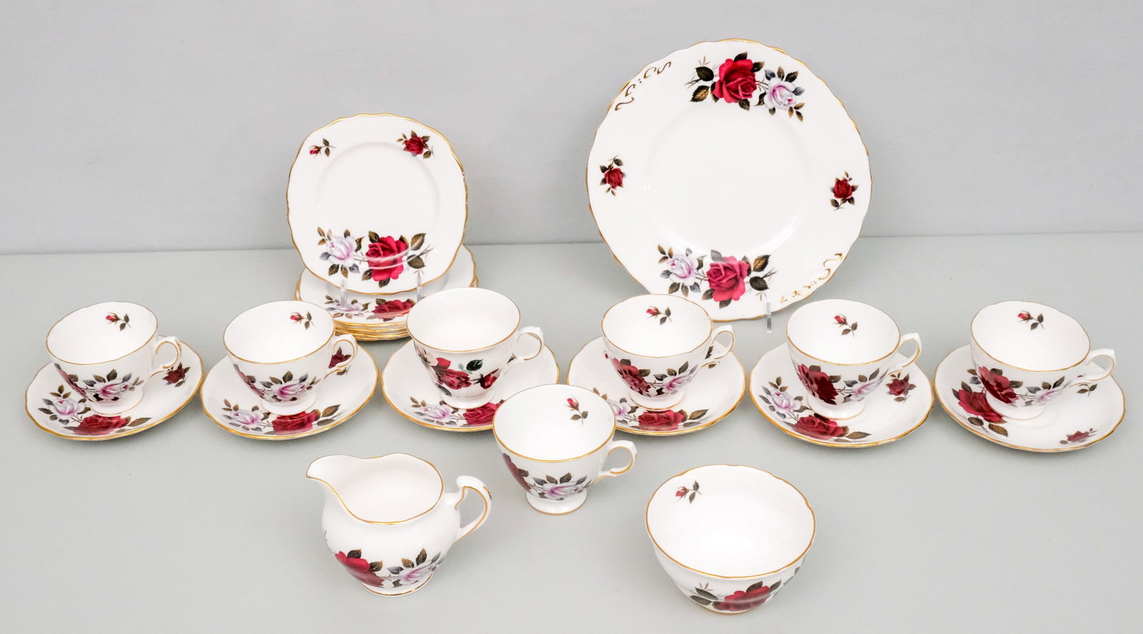 Colclough Porcelain Dessert Service: Comprising (7) cups with (6) saucers, 5 small dessert plates, a cake plate, sugar, and creamer.