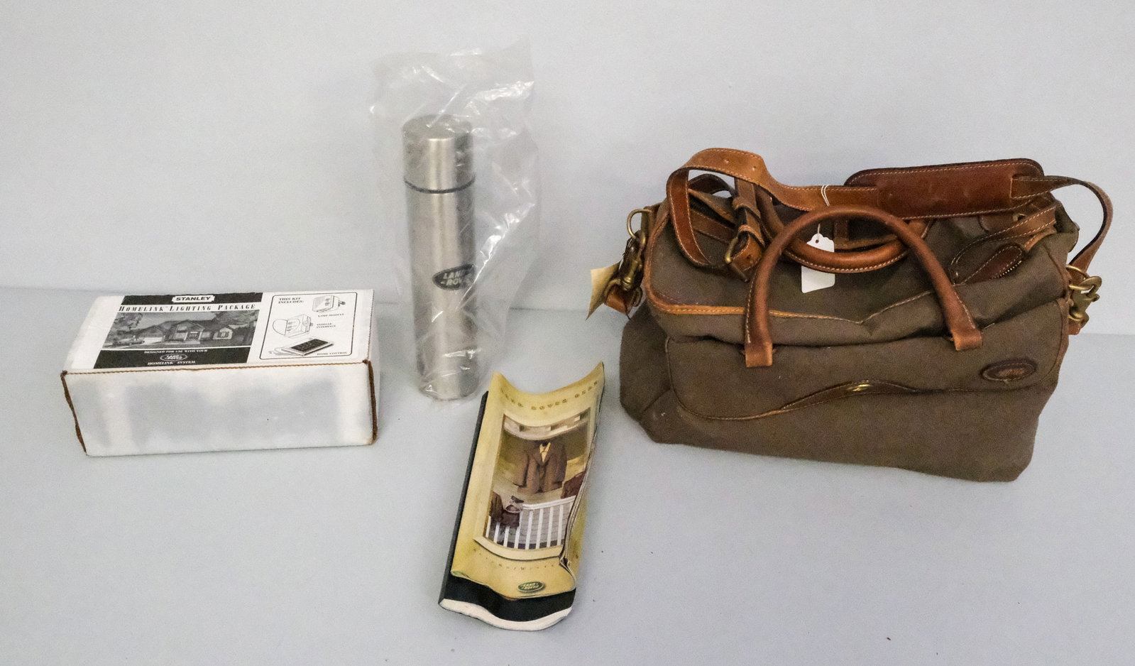 Lot of Land Rover Accessories: Lot consisting of a Holland Brothers bag with Land Rover water bottle and Stanley Homelink Lighting Package.