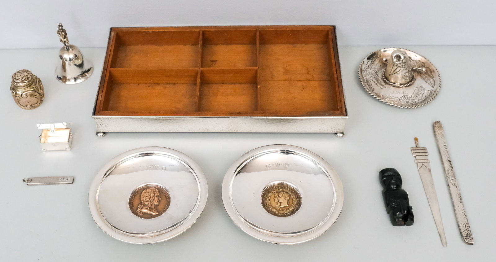 Antique Sterling Silver Group: Comprising shakers, trays, hats, bells, trays with inset coins and more. Combined weighable silver (not including dishes with inset coins or smoking stand) 9.88 troy.
