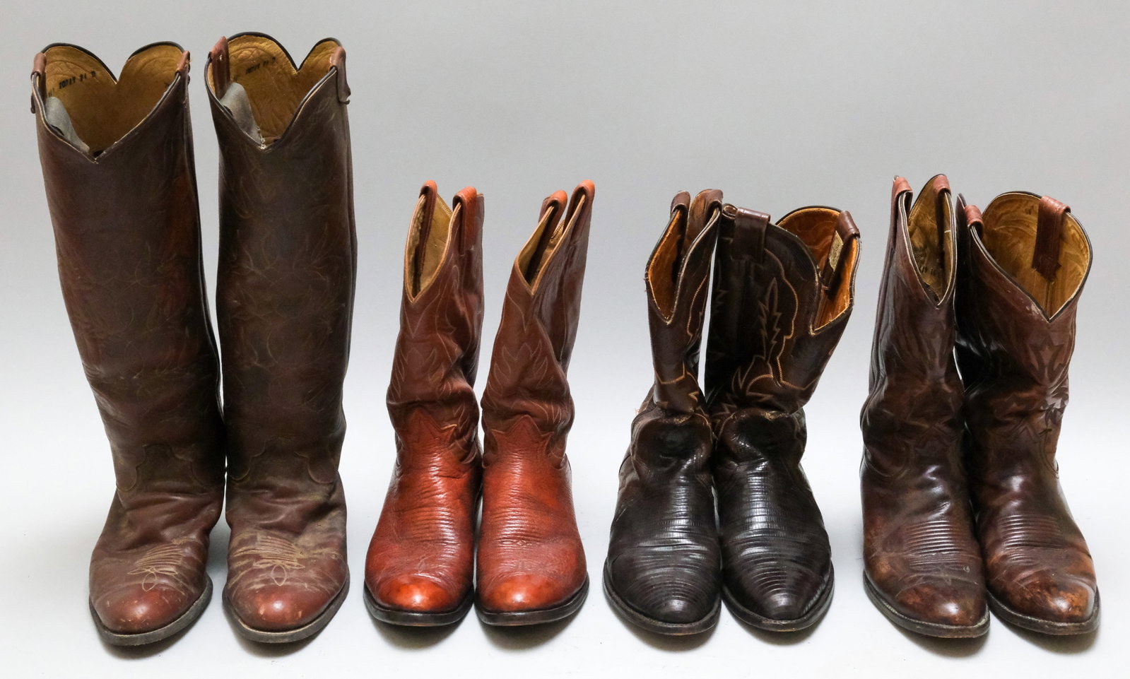 Group of Vintage Western Or Cowboy Boots: Comprising four pairs, a pair by Nocona Boots, two by Tony Lama, and a high leg custom pair with lasts