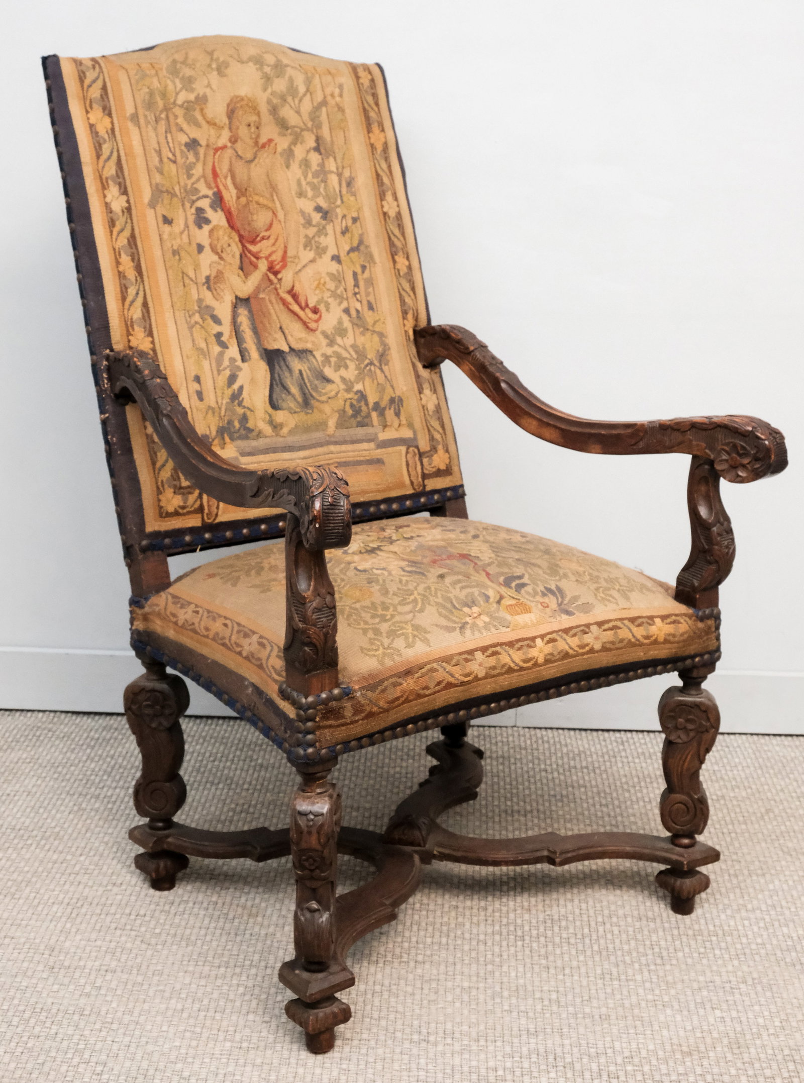 Large Antique Louis Style Carved Armchair: Well carved with scrolling arms and embroidered upholstery depicting Diane.