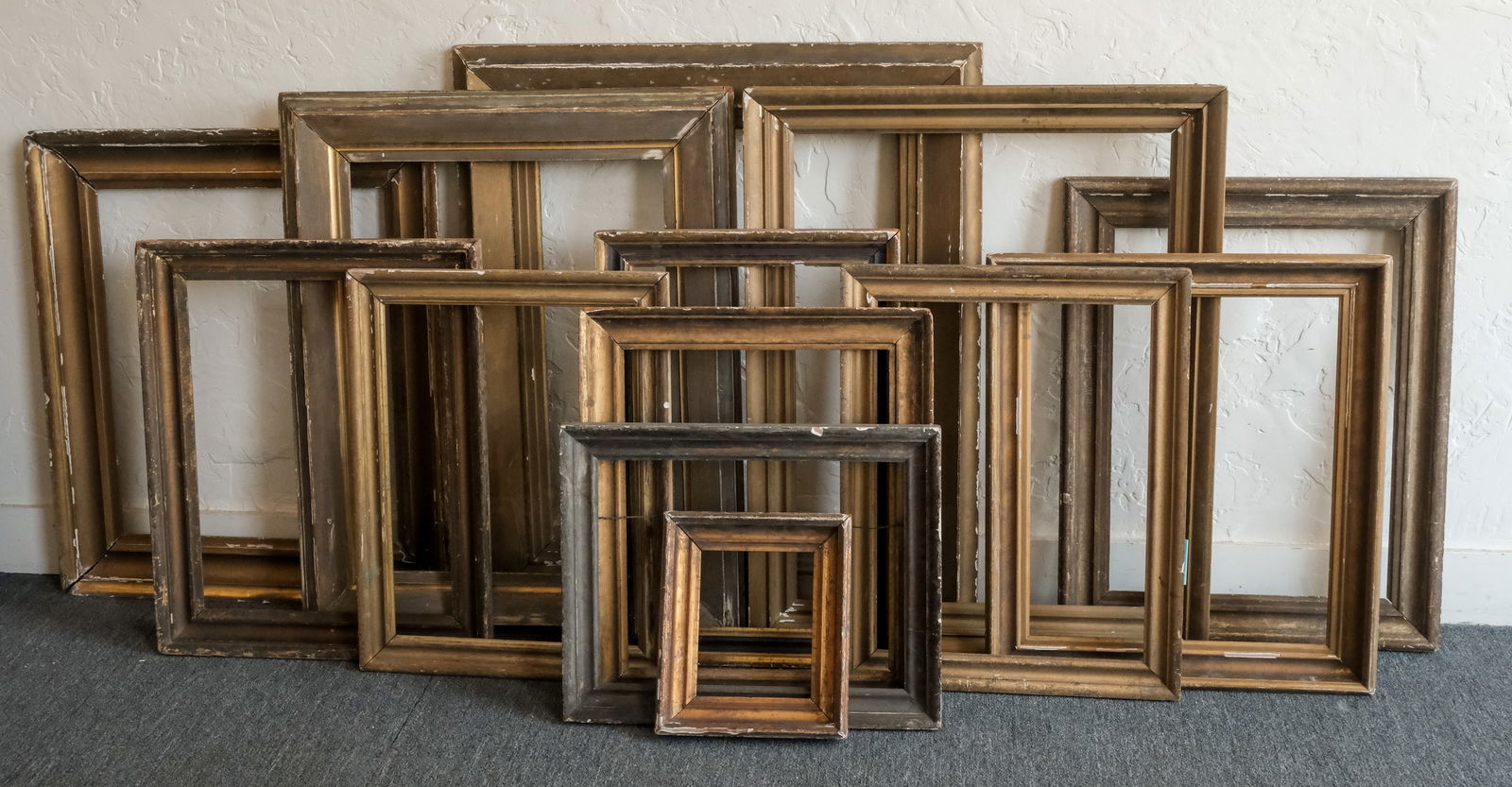 Group of 13 Plain Gilt Frames: A generous lot! Smallest overall 12" x 14", rabbet 8" x 10", 2 1/4" molding, largest overall 36 1/4" x 41 1/2", rabbet 25" x 30 1/2" and 6" molding
