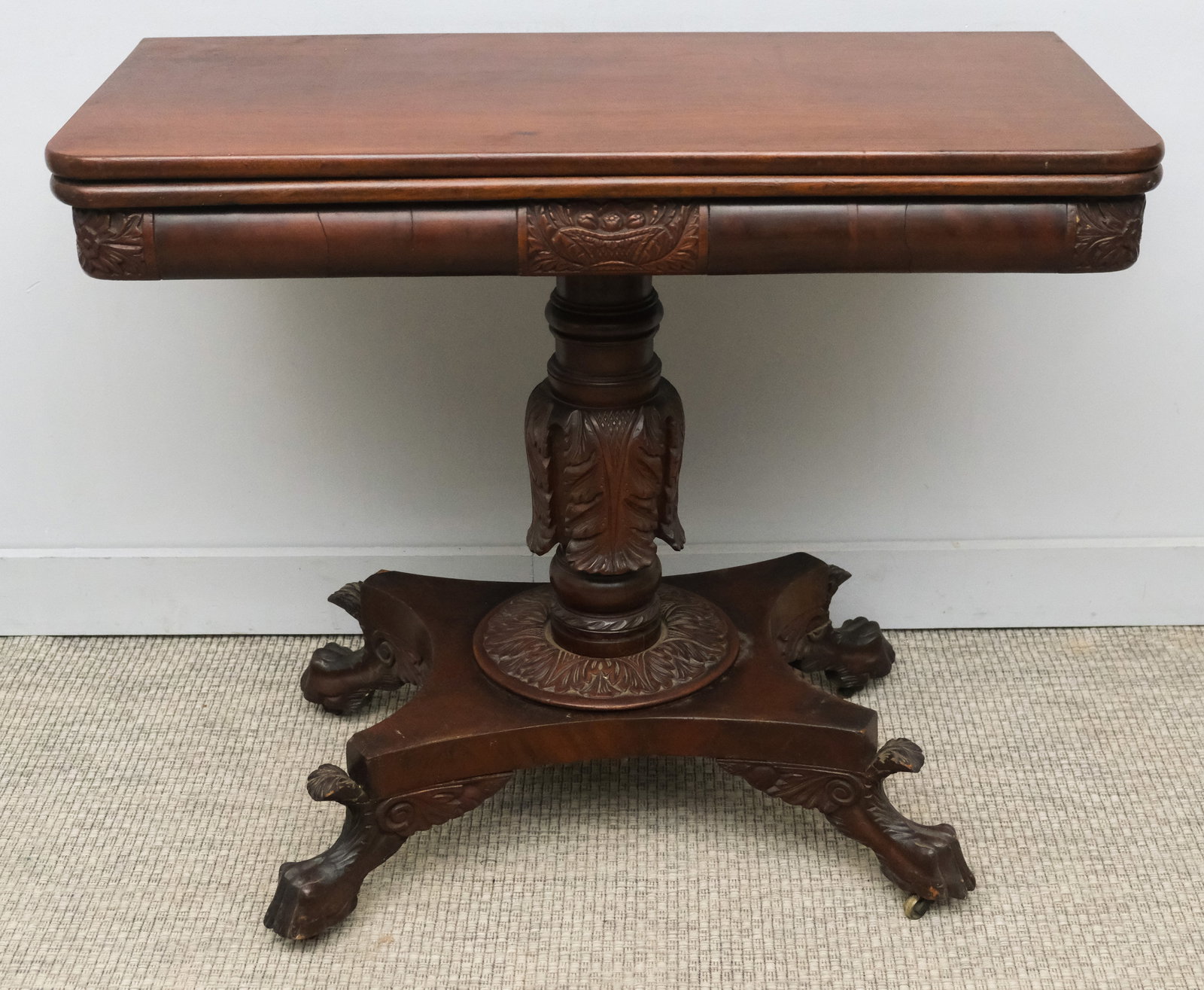 Classical Carved Mahogany Claw-Foot Game Table: American, early 19th century, having carved column and feet on casters, 17 1/2" (closed) 35" (open) x 36" x 30 1/2" H.