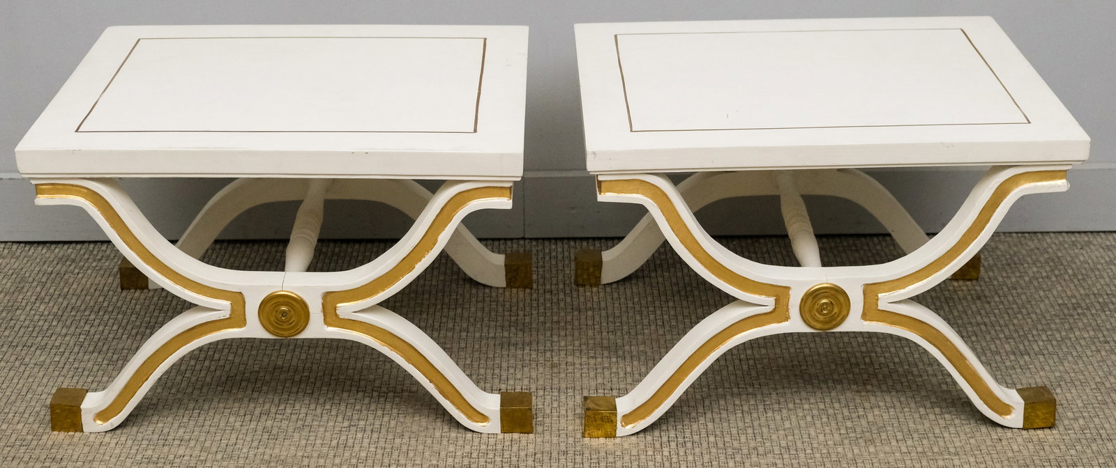 Pair of Parcel Gilt Regency Style End Tables: 20th century, having x-form bases with glossy white painted surface and gilded accents, 24" x 19 1/2" x 16".