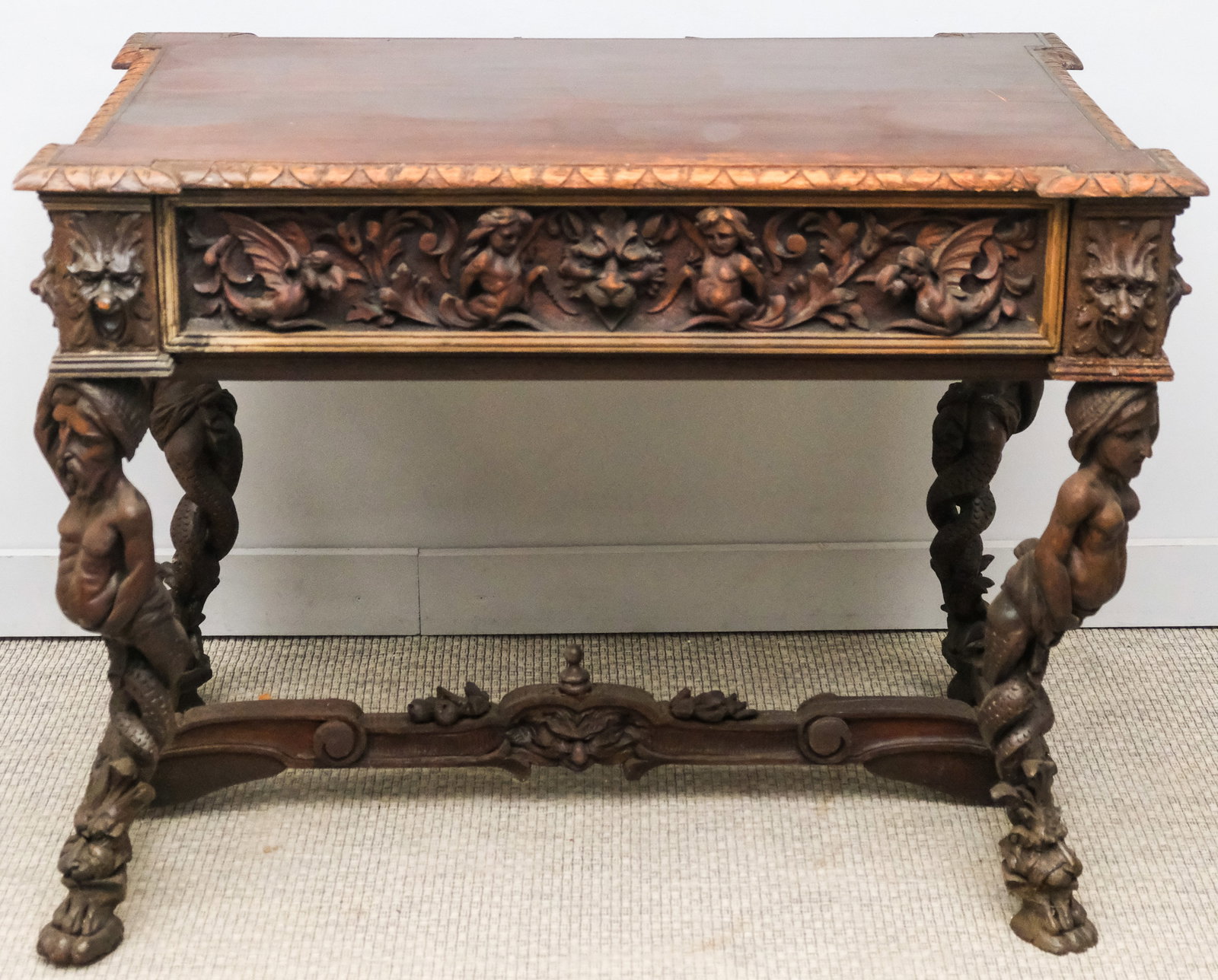 Renaissance Revival Carved Wood Desk: Late 19th century, heavily carved desk having one drawer and figural supports, 41" W 29" D x 31" H.