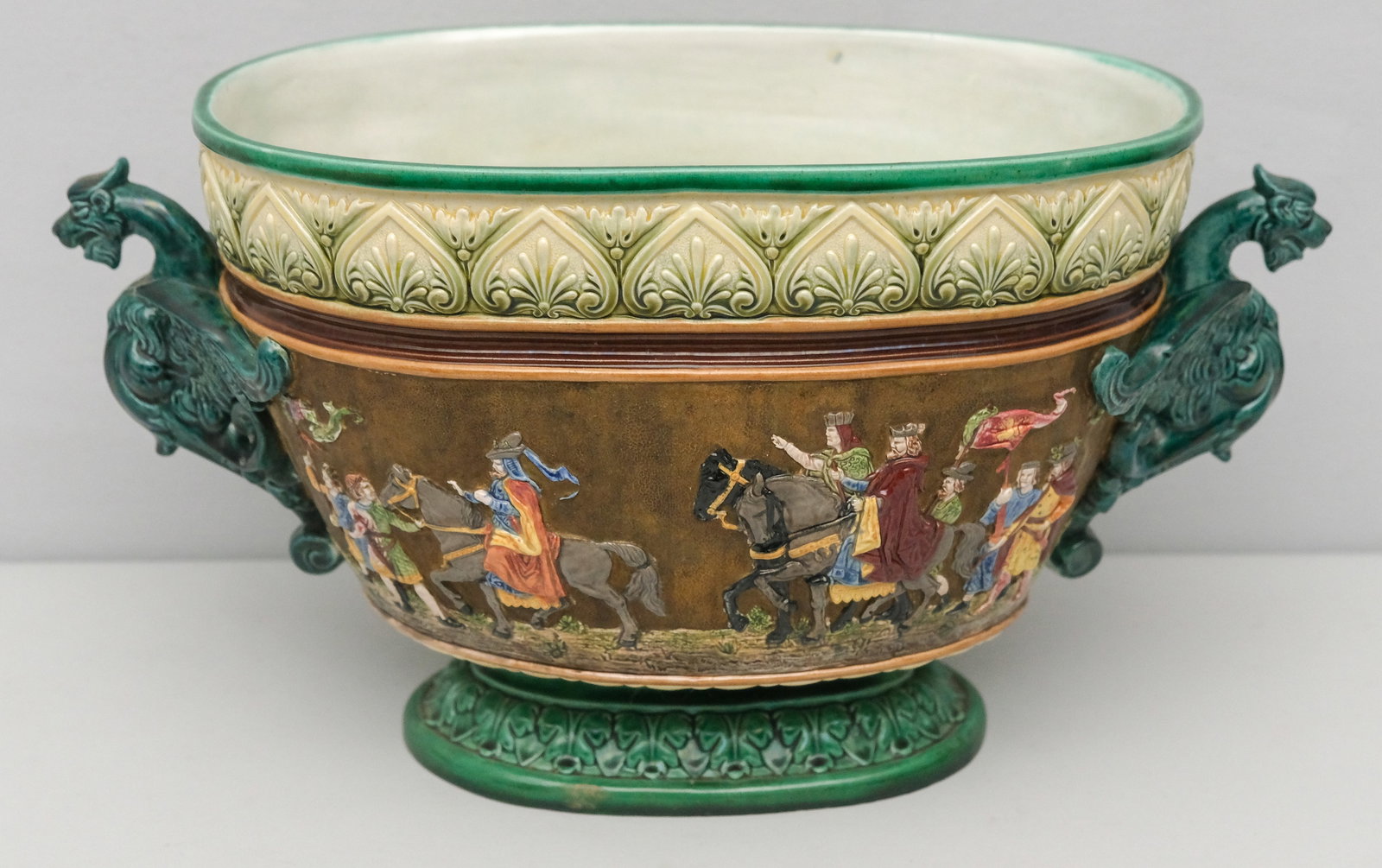Wilhelm Schiller Majolica Pottery Wine Cooler: Parade motif decor with arching gryphon handles.18 1/4". Marked as shown.