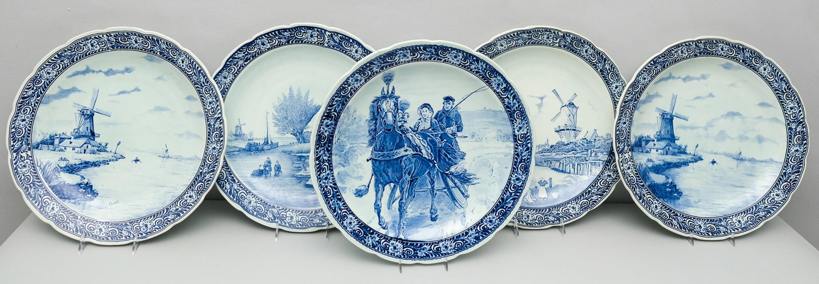 Five Antique Royal Sphinx Delft Chargers: Hand decorated with traditional scenes and palette. Marked as shown, measures 15 3/4" in diameter.