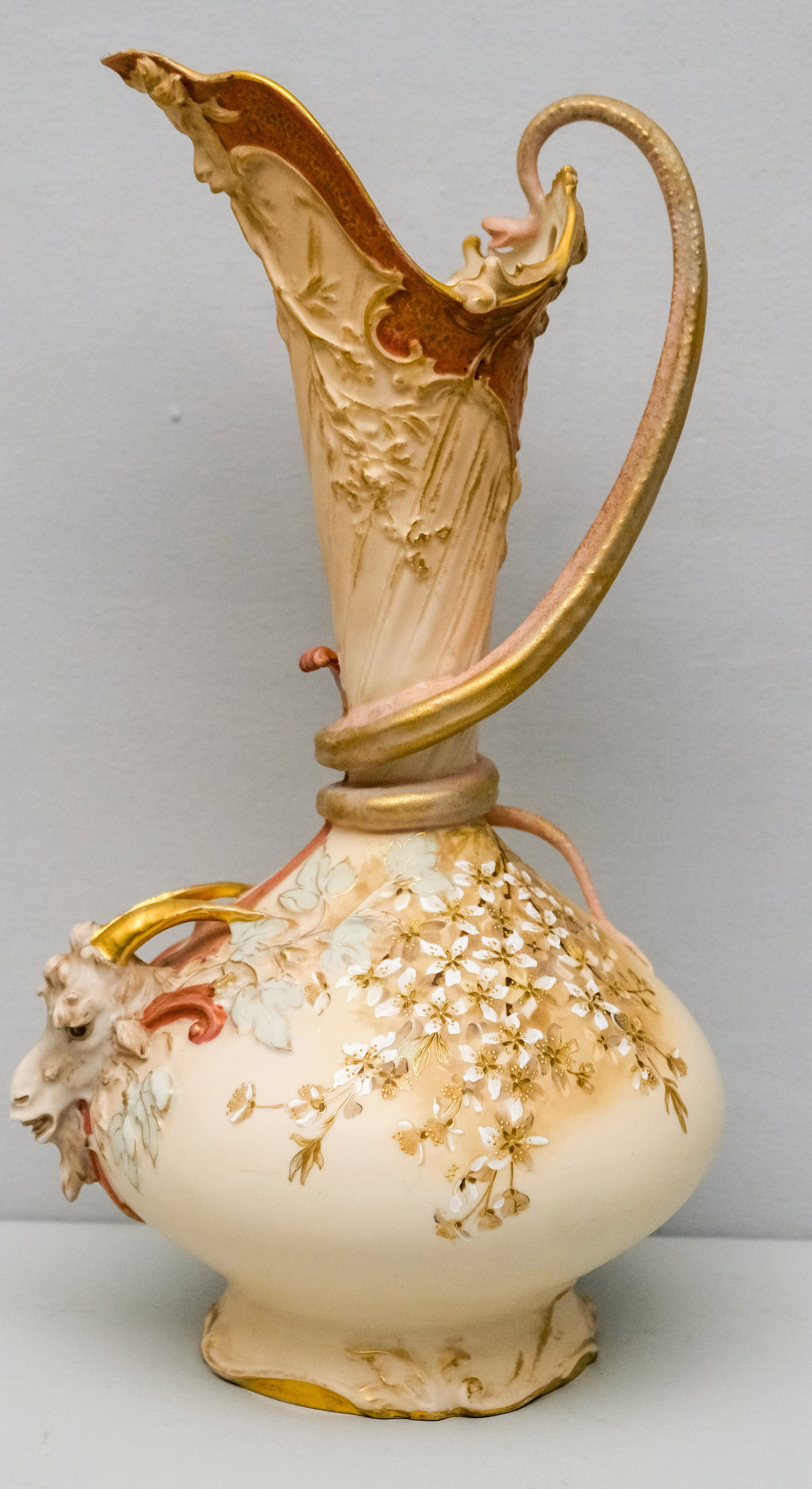Robert Hankey Austrian Figural Ewer: C.1900-1910. Snakelike handle twisting around tall narrowed neck, pierced rim with Bacchanalian and goat masks under spout. Well enameled florals with gilt surround. Marked as shown. 16"