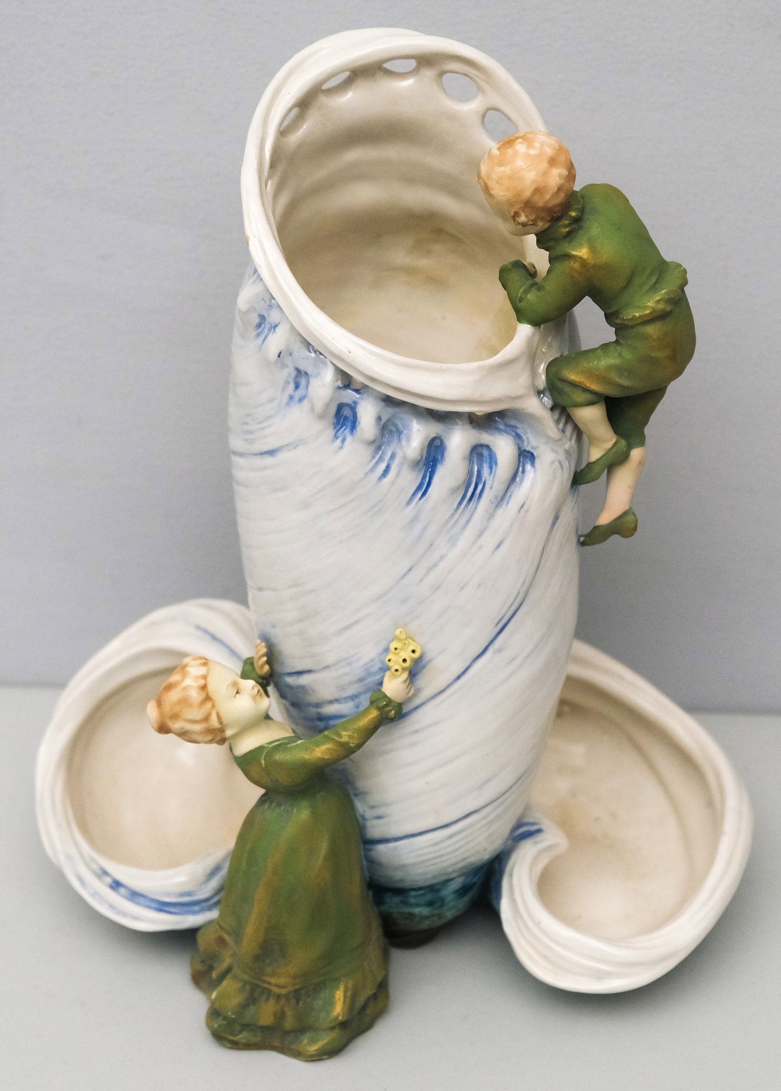Amphora Austria Art Nouveau Pottery Vase: With full figural children dressed in green and sponge gold, climbing upon a reticulated waveform center with clam shell surround. Marked as shown. 12 1/2" H x 10" W