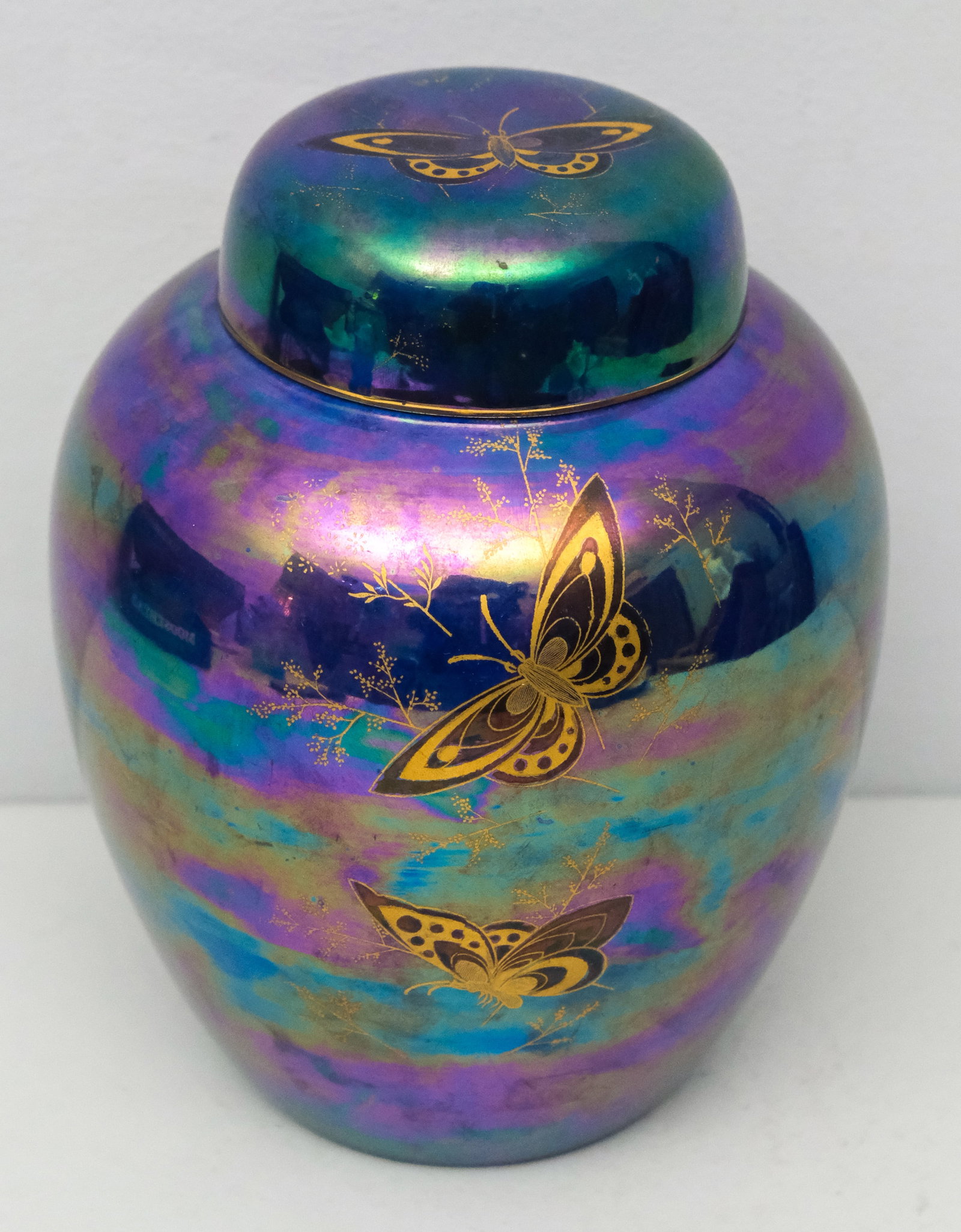 Devon Lustrine Pottery Covered Jar: Dark blue luster decorated with butterflies. Marked as shown. 9 1/4" with lid.