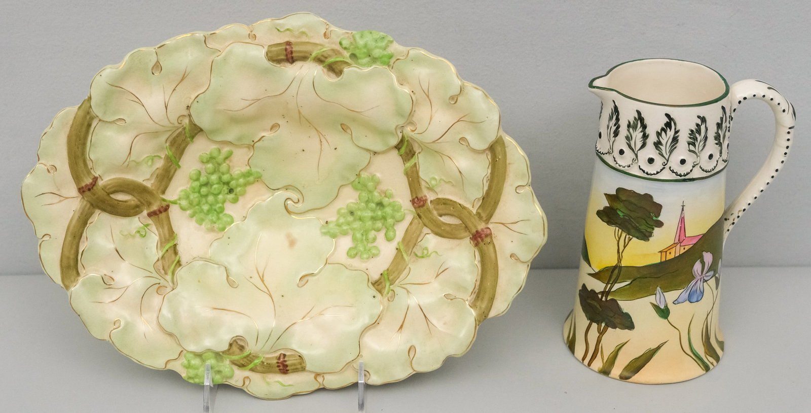 Hampshire & New Hampshire Pottery Group: Comprising a landscape decorated pitcher by J.S. Taft of Keene, New Hampshire, and a Hampshire Pottery bowl decorated with grapes. Marked as shown. Pitcher 7 1/2", bowl 12 1/2"L x 9 1/4"W x 2 1/2"H