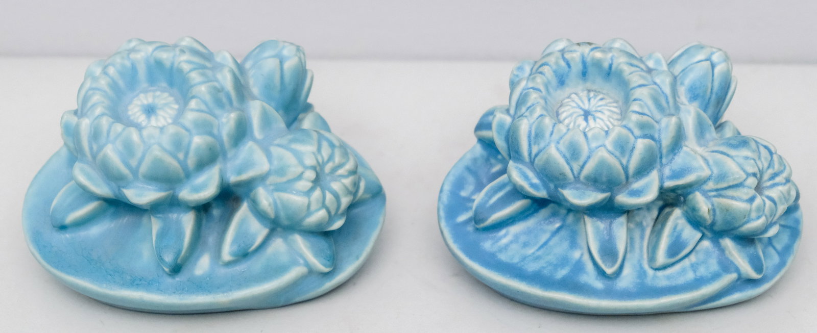 Rookwood Floral Art Pottery Bookends: C. 1939, in a matte blue finish. Marked as shown. Each measures 5 1/2".