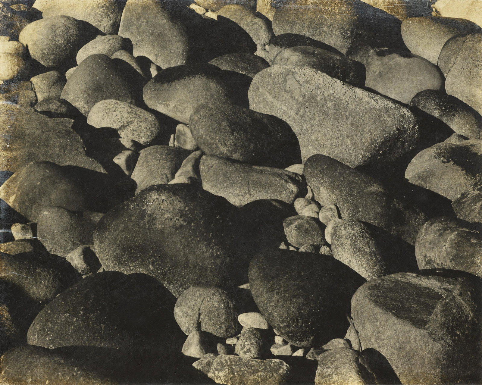 EDWARD WESTON - Rocks, Point Lobos, 1930: This rare vintage print of a scarcely known image by Edward Weston is one of the last in private hands. At this time, circa 1930, Weston initialed and editioned his mounts beneath the image with a ful