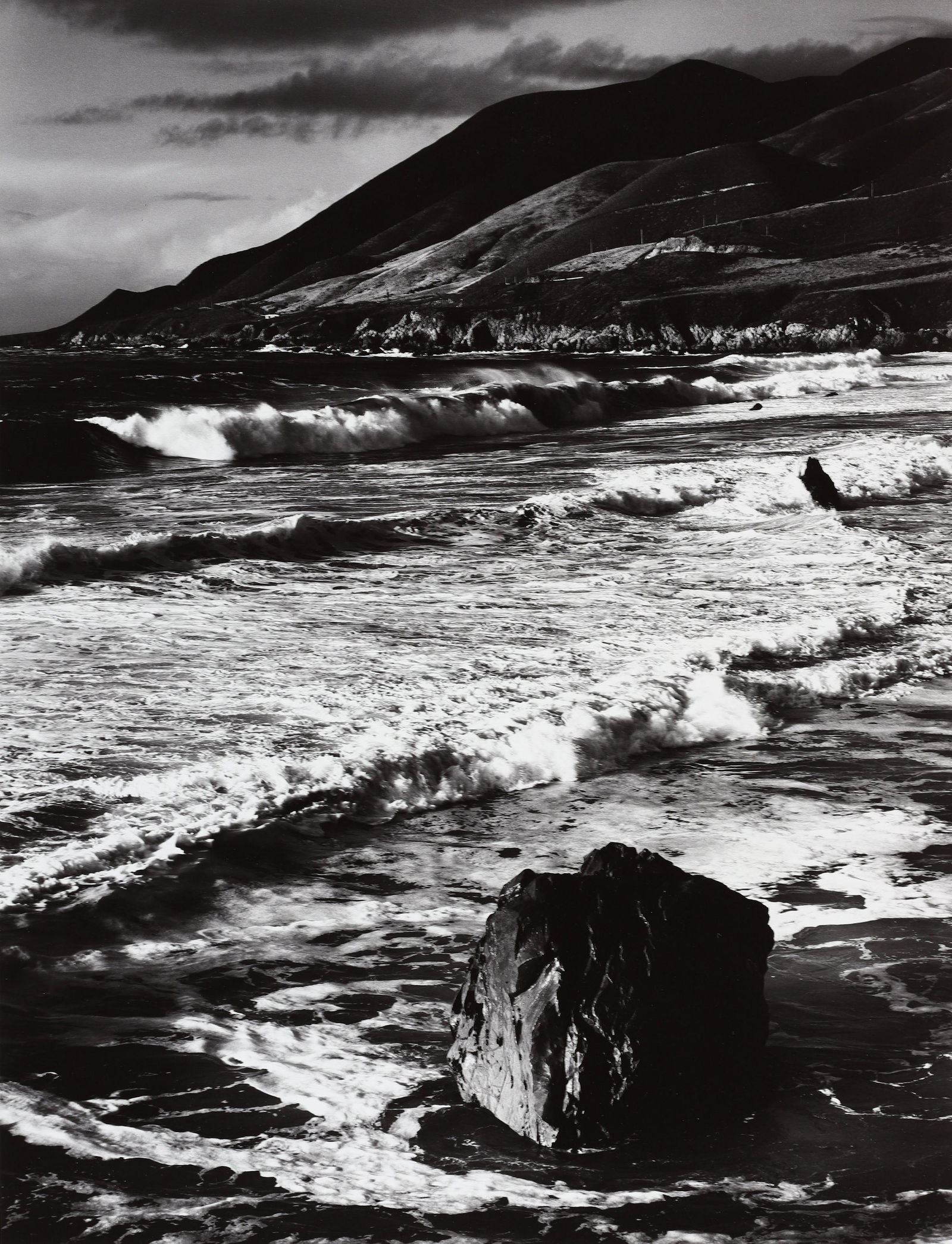 MORLEY BAER - Winter Surf, 1966: One of Morley Baer"s greatest seascapes, this image was taken just outside Baer"s home on the bluff at Garrapata Beach in Big Sur, CA. A later enlargement, this print is signed in pencil mount recto a
