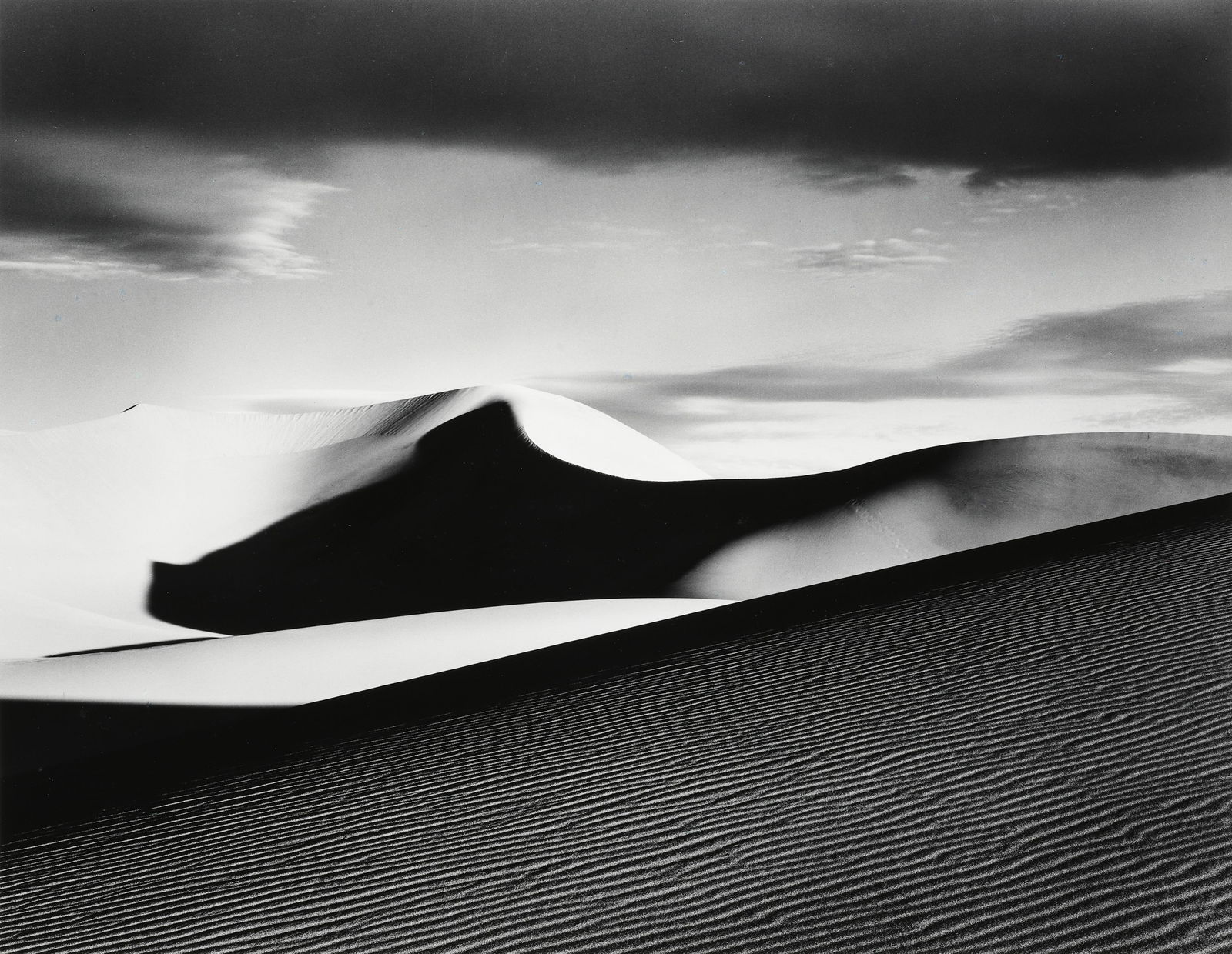 JOHN SEXTON - Sand Dunes, Clouds, Sunrise, Death: ARTIST: JOHN SEXTON TITLE: "Sand Dunes, Clouds, Sunrise, Death Valley, CA, 1980" MEDIUM: Vintage silver gelatin print, mounted. Printed 1985. SIZE: Image - 10 1/2" x 13 3/8", Mount/Mat - 16" x 20" D