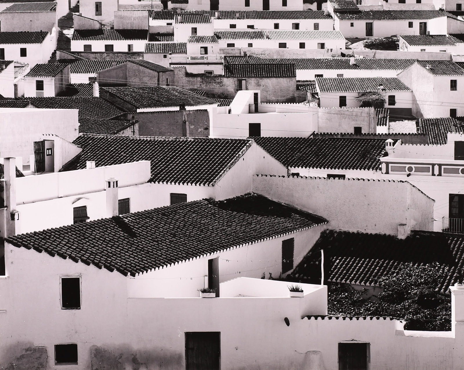BRETT WESTON - Rooftops, Spain, 1960: ARTIST: Brett Weston TITLE: Rooftops, Spain, 1960 MEDIUM: Silver Gelatin IMAGE SIZE: 7 5/8 x 9 1/2 in DESCRIPTION: This silver gelatin print is signed and dated in pencil mount recto. Accompanied by a