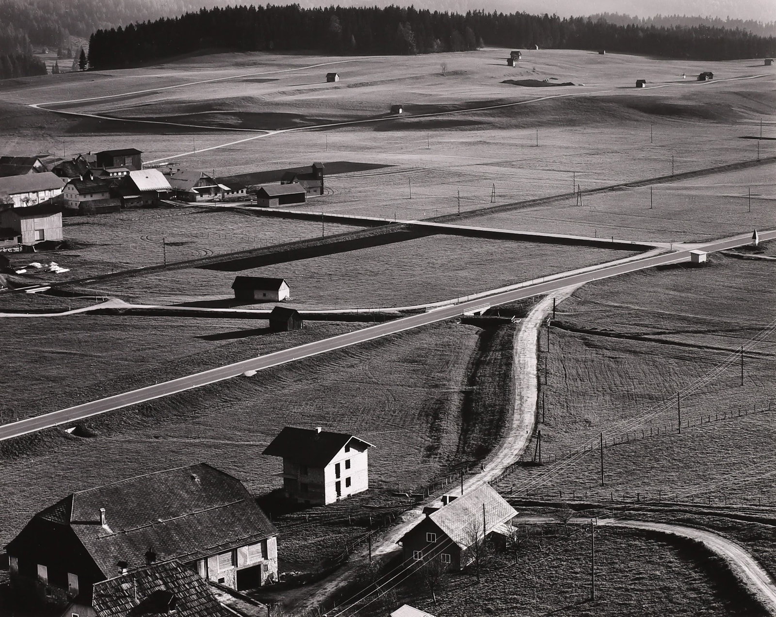 BRETT WESTON - Farms, Austria, 1972: ARTIST: Brett Weston TITLE: Farms, Austria, 1972 MEDIUM: Vintage Silver Gelatin IMAGE SIZE: 7 5/8 x 9 5/8 in DESCRIPTION: This vintage silver gelatin print is signed and dated in pencil mount recto. A