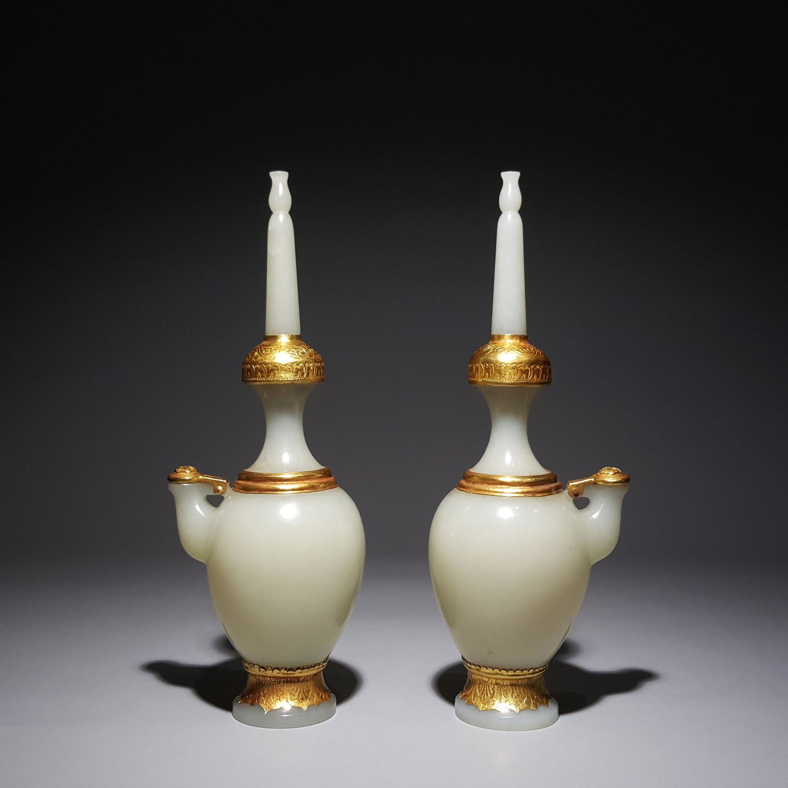 A PAIR OF HETIAN JADE AND SILVER GILT LONG NECK HIP: Name A PAIR OF HETIAN JADE AND SILVER GILT LONG NECK HIP FLASKS Dimensions 19 x 7cmWt375g Condition Additional photographs and Condition reports are provided by request as a courtesy to our