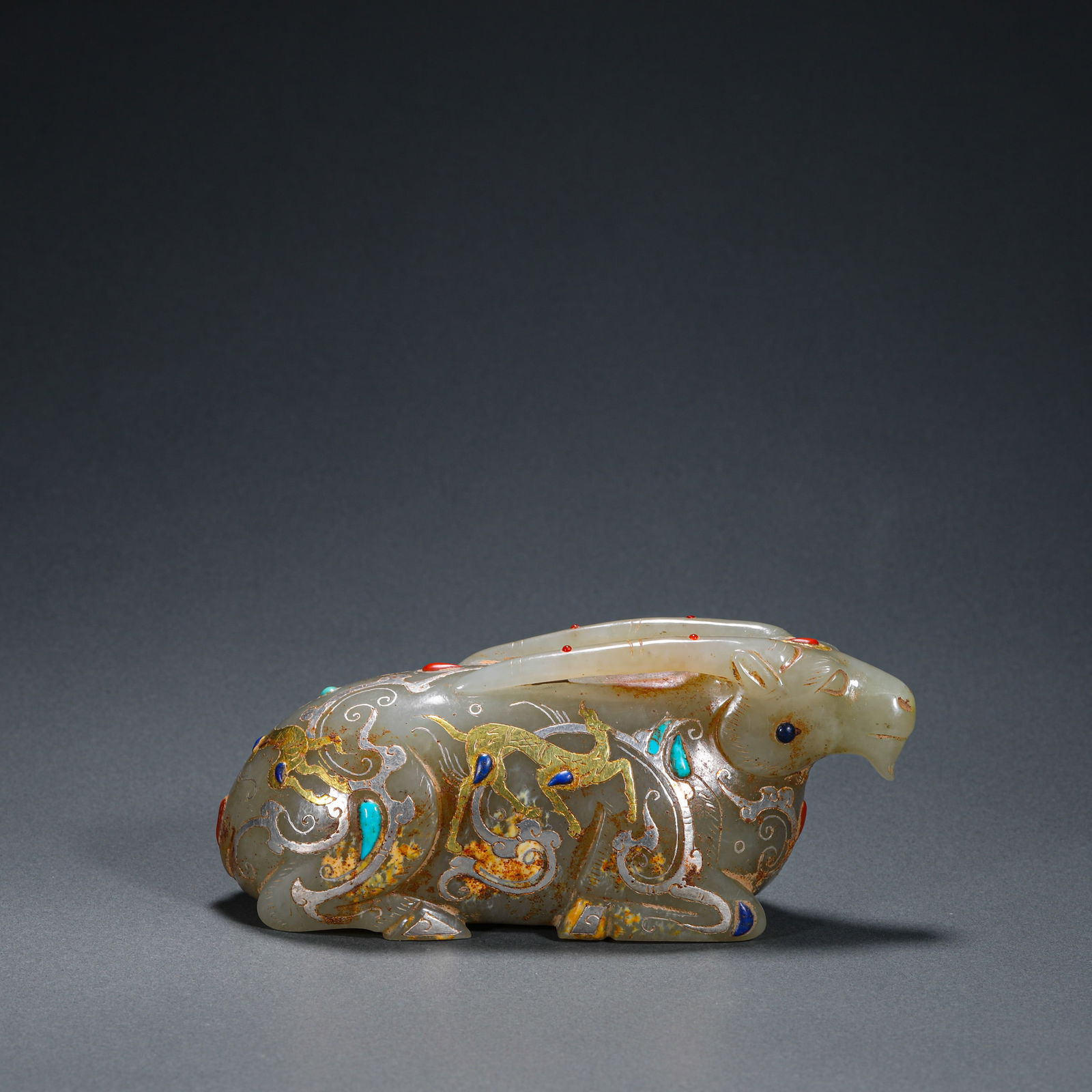 Han Dynasty jade inlaid gold and silver inlaid gemstones in the shape of a reclining sheep (1 of 8)
