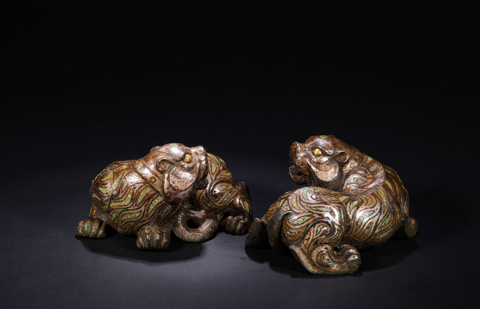 A pair of copper cuo gold and silver auspicious beasts from the Han Dynasty (1 of 7)