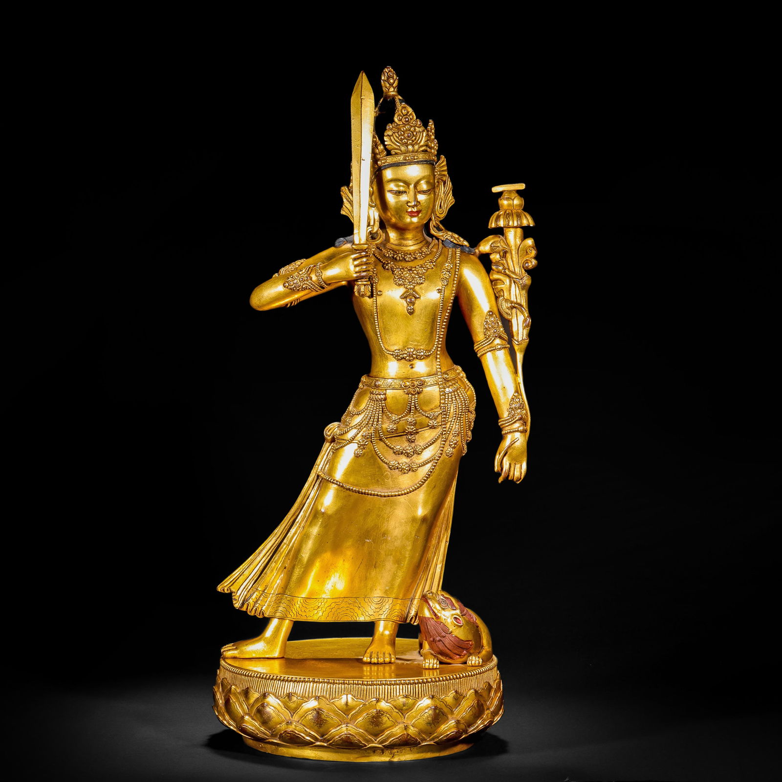 A GILDED BRONZE STATUE OF A BODHISATTVA HOLDING A SWORD AND A LOTUS HAND FROM THE QING DYNASTY: Name A GILDED BRONZE STATUE OF A BODHISATTVA HOLDING A SWORD AND A LOTUS HAND FROM THE QING DYNASTY Dimensions H:40cm W:20cm Weight6400g This type of gilded copper statues were mostly used for worship