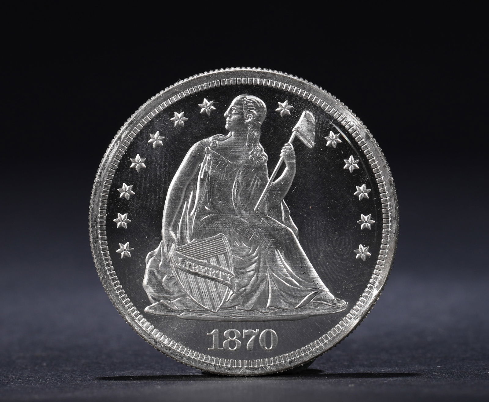 A SILVER COIN FEATURING A SEATED STATUE OF THE STATUE OF LIBERTY FROM 1870, USA: Name A SILVER COIN FEATURING A SEATED STATUE OF THE STATUE OF LIBERTY FROM 1870, USA Dimensions D:3.7cm Weight:27g Condition Additional photographs and condition reports are availa