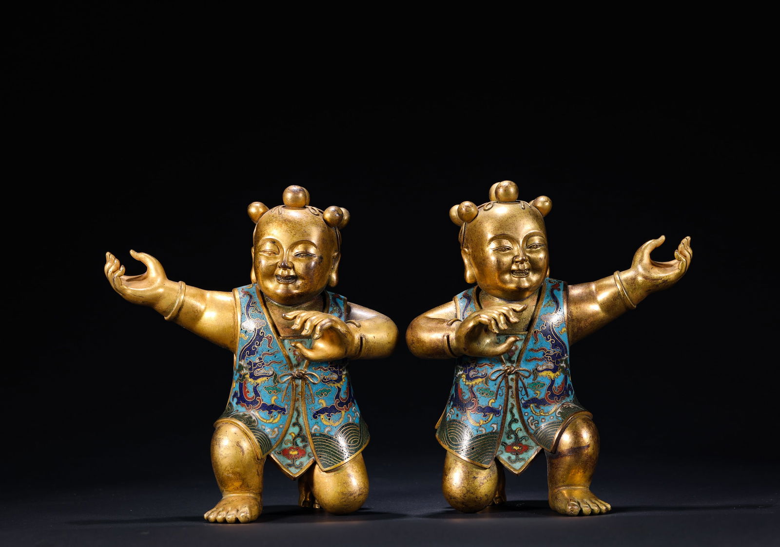 QING DYNASTY, GILDED COPPER CLOISONNE ENAMEL BOY: Name QING DYNASTY, GILDED COPPER CLOISONNE ENAMEL BOY Dimensions H: 13 CM; W: 11.5 CM; WEI GHT: 580 GTHIS IS A PAIR OF GILT-BRONZE CLOISONN? ENAMEL BOY FI GURINES, MASTERPIECES OF QIN G COURT CRAFTSMA