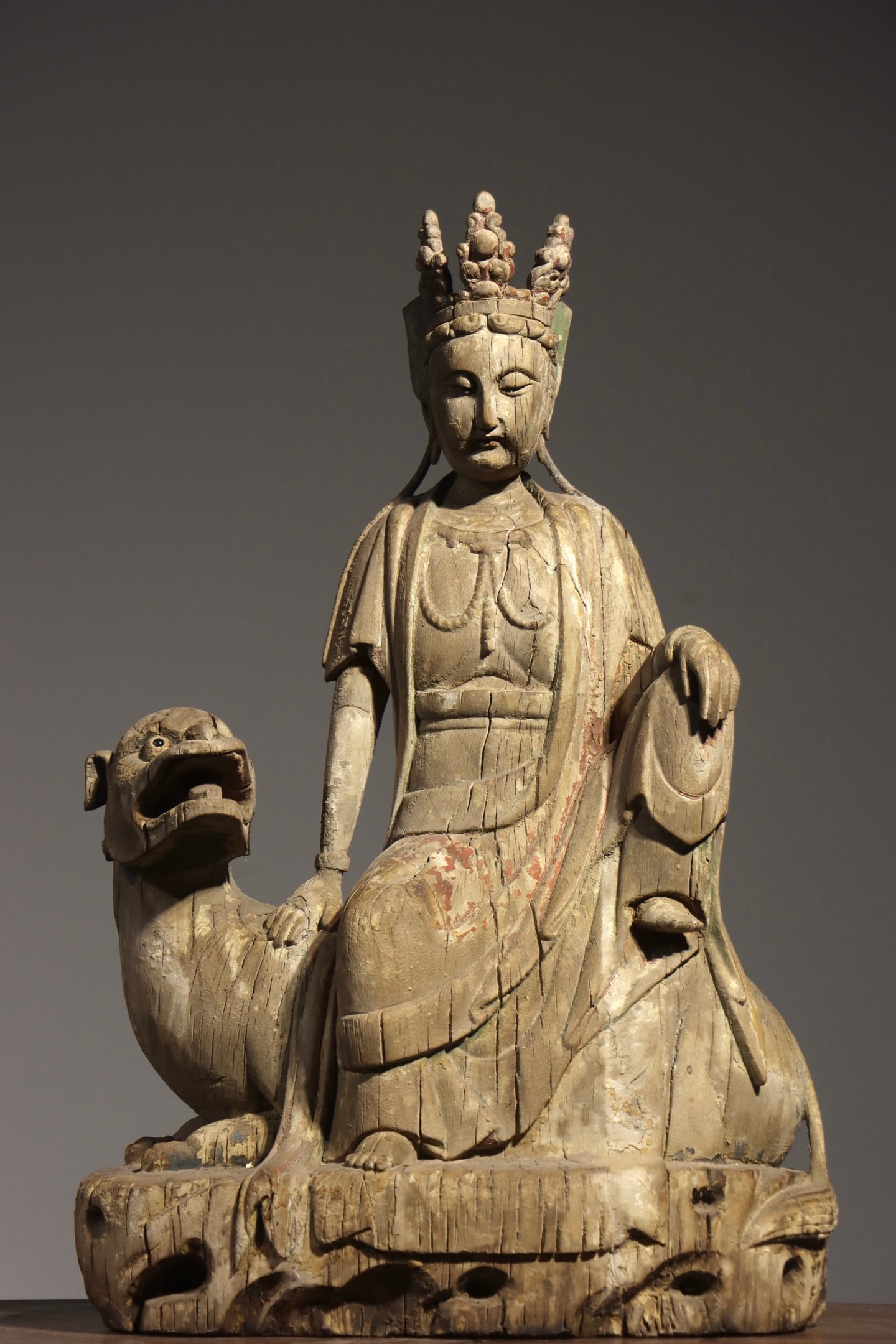 A TANG DYNASTY PAINTED WOODCARVING OF MANJUSRI BODHISATTVA RIDING A LION (1 of 10)
