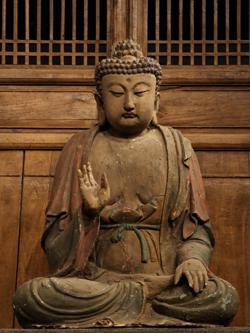MING DYNASTY NANMU SAKYAMUNI SITTING BUDDHA: Name MING DYNASTY NANMU SAKYAMUNI SITTING BUDDHA Dimensions H: 90 CM; L: 66 CM; W: 42 CMTHIS IS A WOODEN SEATED STATUE OF SHAKYAMUNI BUDDHA, A CLASSIC WORK OF ANCIENT CHINESE BUDDHIST WOOD CARVIN