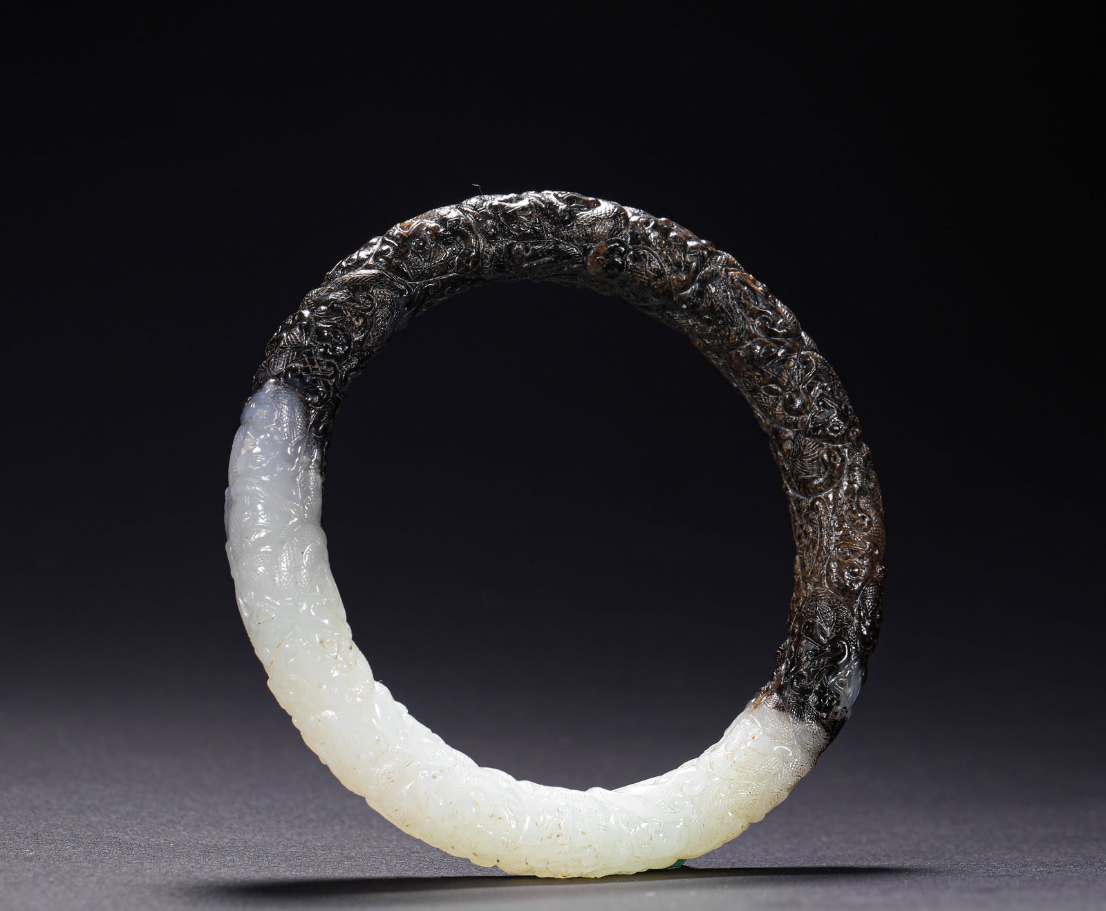 HETIAN JADE BLACK PATINA BRACELET FROM THE HAN DYNASTY: Name HETIAN JADE BLACK PATINA BRACELET FROM THE HAN DYNASTY Dimensions D: 7.7 CM; WEI GHT: 50 G Condition Additional photographs and condition reports are available upon request as a