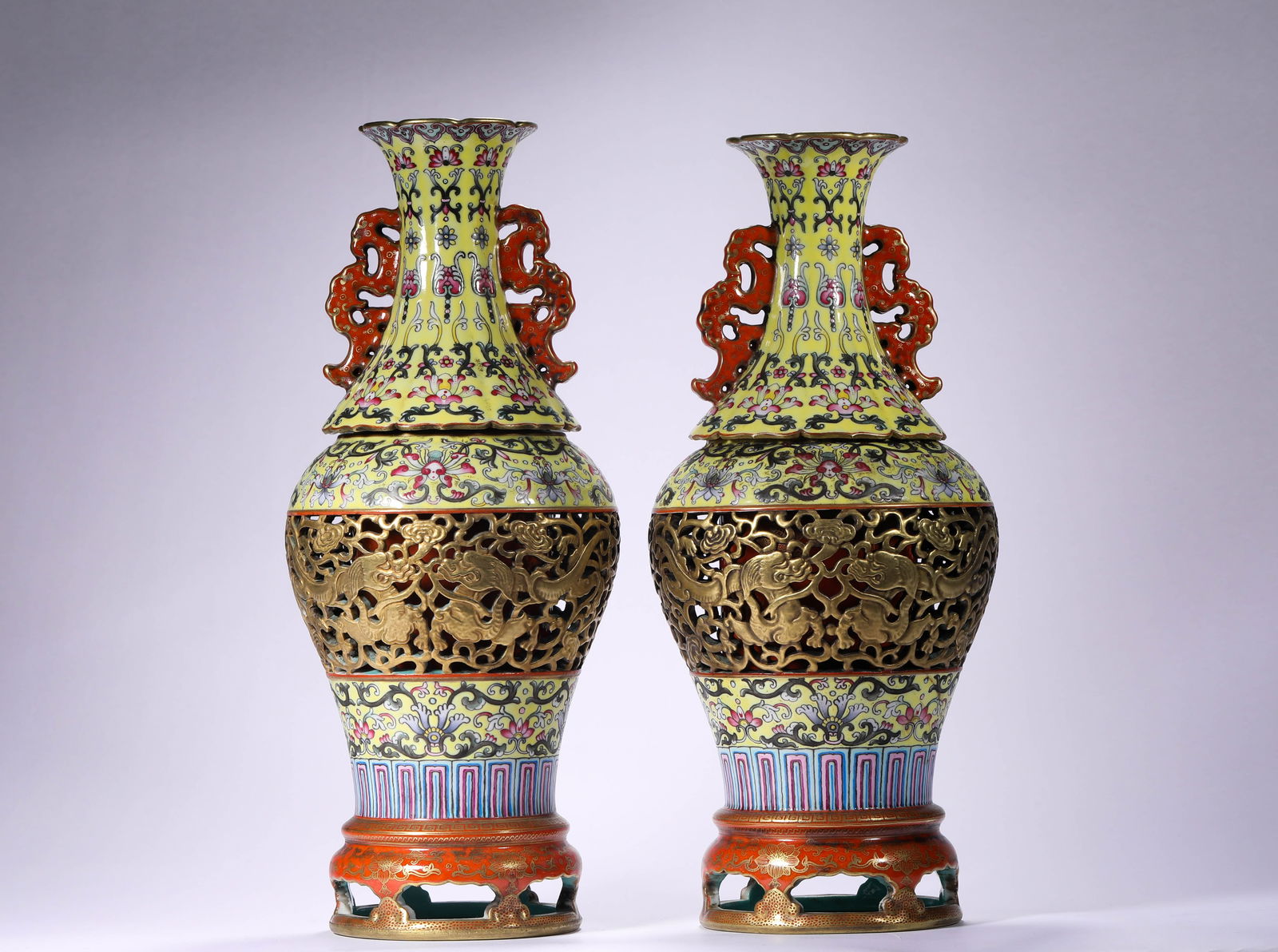 QIANLONG HOLLOWED-OUT ENAMEL REVOLVING VASES OF THE QING DYNASTY: Name QIANLONG HOLLOWED-OUT ENAMEL REVOLVING VASES OF THE QING DYNASTY Dimensions H: 33 CM; W: 12 CMTHIS IS A PAIR OF YELLOW- GROUND POLYCHROME GILDED HOLLOWED-OUT ROTATIN G HEART VASES FROM THE QIANLO