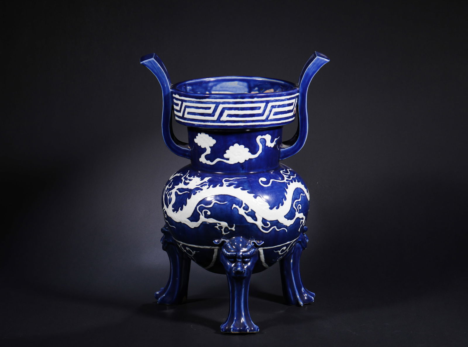 A YUAN DYNASTY INCENSE BURNER WITH A WHITE DRAGON PATTERN LEFT BLANK IN BLUE GLAZE: Name A YUAN DYNASTY INCENSE BURNER WITH A WHITE DRAGON PATTERN LEFT BLANK IN BLUE GLAZE Dimensions H: 41 CM; D: 27 CMTHIS IS A DOUBLE-EARED THREE-LE G GED FURNACE WITH BLANK DRA GON PATTERNS EN GRAVED