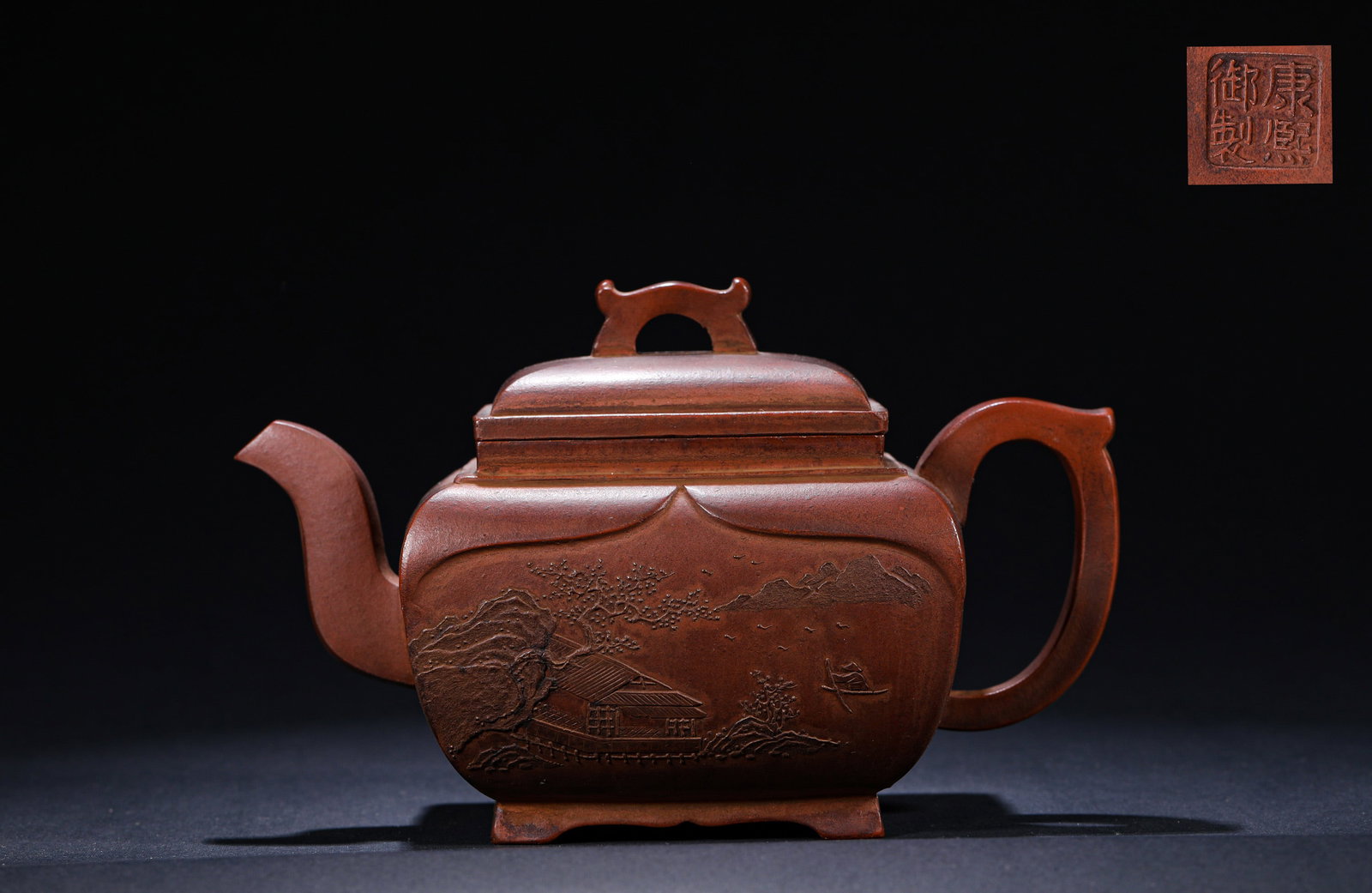A CLAY PAINTING LANDSCAPE SQUARE PURPLE CLAY TEAPOT MADE BY EMPEROR KANGXI OF THE QING DYNASTY: Name A CLAY PAINTING LANDSCAPE SQUARE PURPLE CLAY TEAPOT MADE BY EMPEROR KANGXI OF THE QING DYNASTY Dimensions H:12cmW:17cm This is a square Yixing clay teapot with painted landscape patterns, imperia