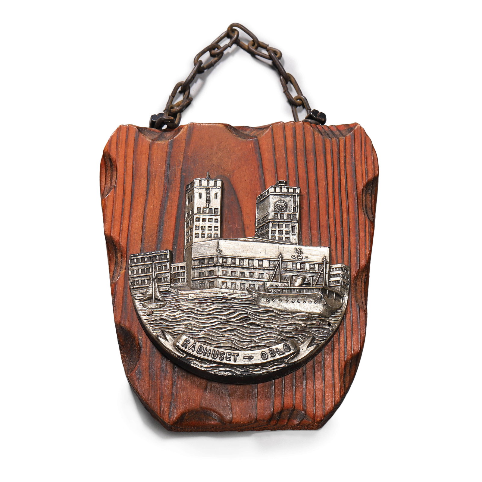 WOODEN PLAQUE WITH OSLO CITY HALL RELIEF: Dimensions: 5 3/4 x 5 1/8 in. (14.5 x 13 cm) A wooden wall plaque featuring a detailed metal relief of Oslo City Hall (R?dhuset), Norway. The relief depicts the iconic twin-towered structure alongside