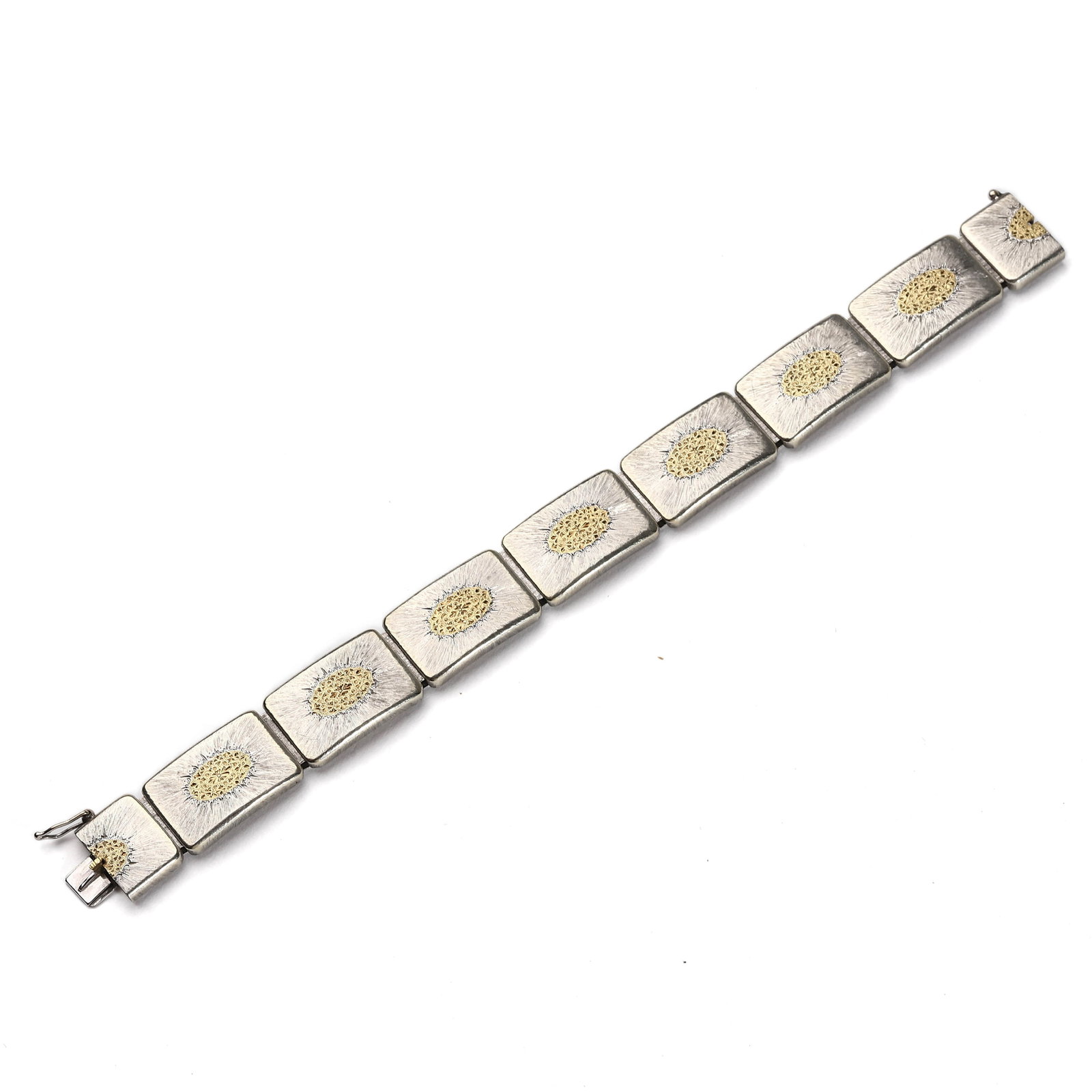 BUCCELLATI SILVER AND GOLD LINK BRACELET WITH FILIGREE MEDALLIONS: Dimensions: Length: 7 1/4 in. (18.5 cm); Weight: 39 g Description: An elegant and substantial silver and gold bracelet by Buccellati, composed of eight slightly curved rectangular links. Each link is 