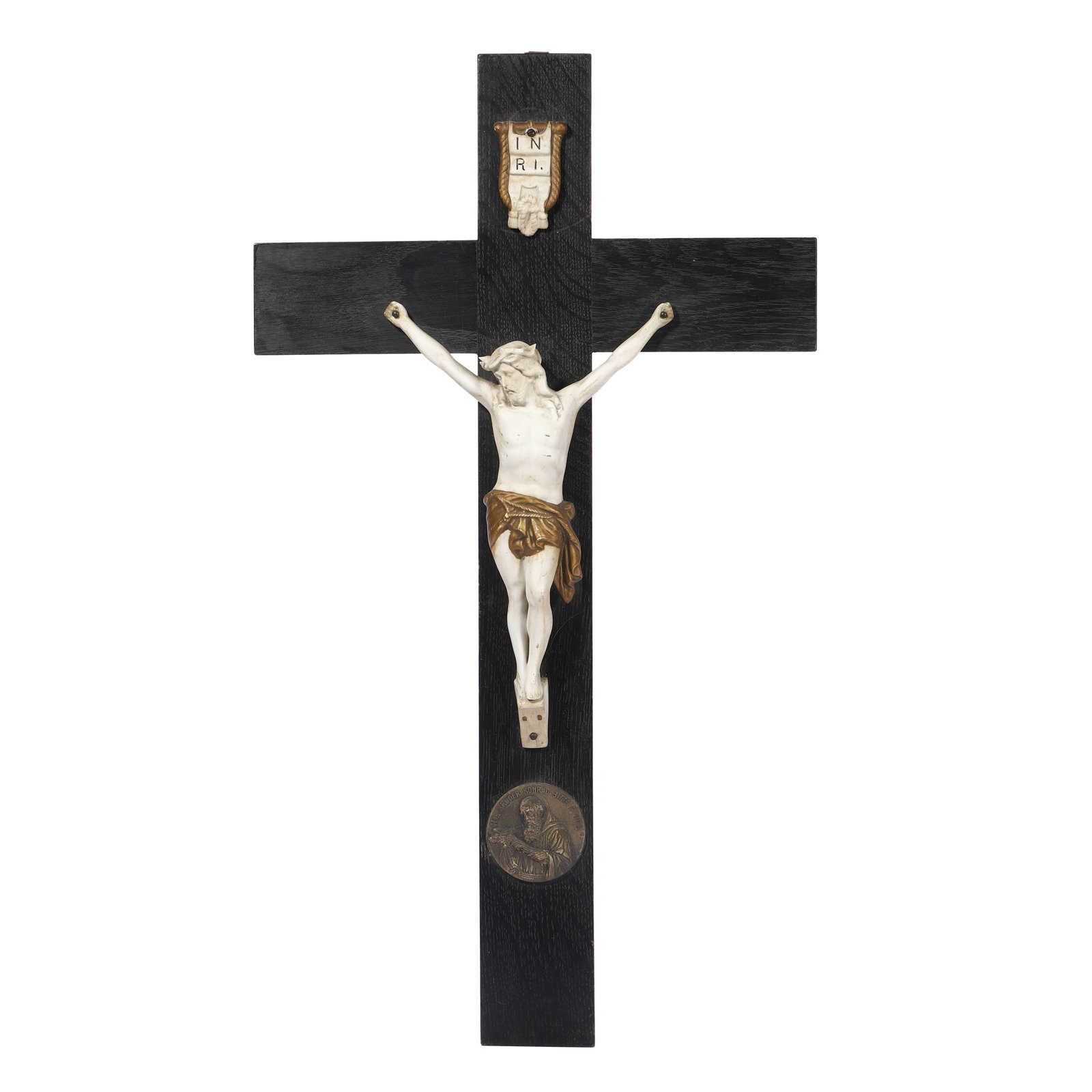 GERMAN SCHOOL, MID-20TH CENTURY ???CRUCIFIX WITH SAINT KONRAD MEDALLION.: GERMAN SCHOOL, MID-20TH CENTURY - CRUCIFIX WITH SAINT KONRAD MEDALLION. Medium:?Wood and ceramic with applied bronze medallion. Dimensions:?Height: 23 5/8 in. (60 cm); Width: 9 1/2 in. (24 cm). Descri