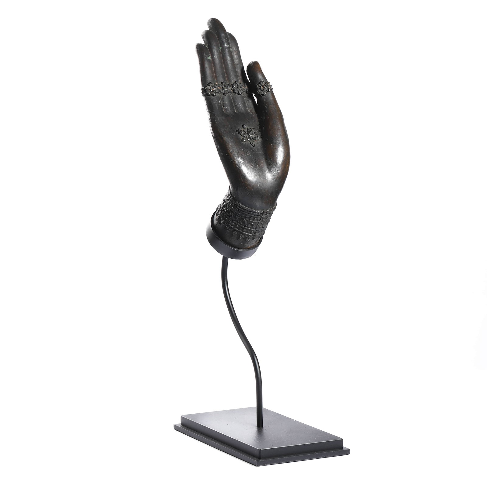 A BRONZE SCULPTURE OF A BUDDHA HAND: Dimensions: Height: 15 3/4 in (40 cm) Description: A finely cast bronze sculpture depicting the right hand of Buddha in abhaya mudra (gesture of reassurance and blessing), elegantly raised with the pa