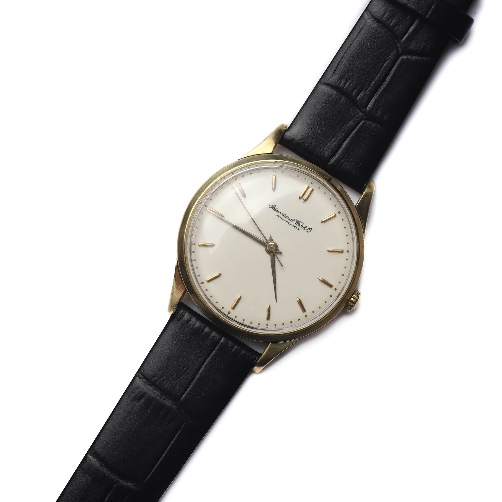 INTERNATIONAL WATCH CO. (IWC) MANUAL WIND WRISTWATCH: Dimensions Dial diameter: 1 7/16in (36.9mm); Overall length: 9 7/16in (24cm) Description A classic International Watch Co. (IWC) manual wind wristwatch featuring a gold-tone case and a clean, understa