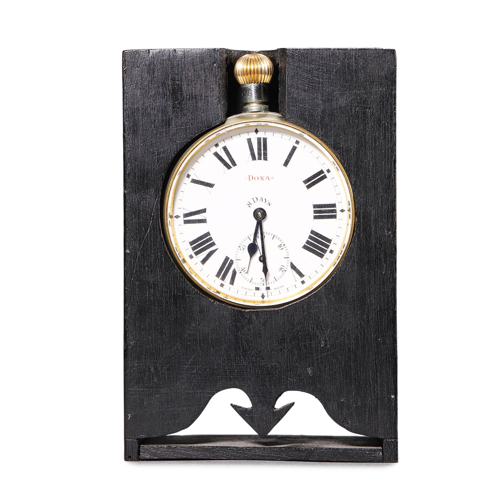 DOXA 8-DAY POCKET WATCH MOUNTED IN A CUSTOM WOODEN DESK STAND: A rare Doxa 8-day pocket watch, measuring 2 3/8 in. (6 cm) in diameter, housed in a custom black wooden stand that transforms it into a functional desk clock. The stand itself measures 5 1/8 in. (13 c