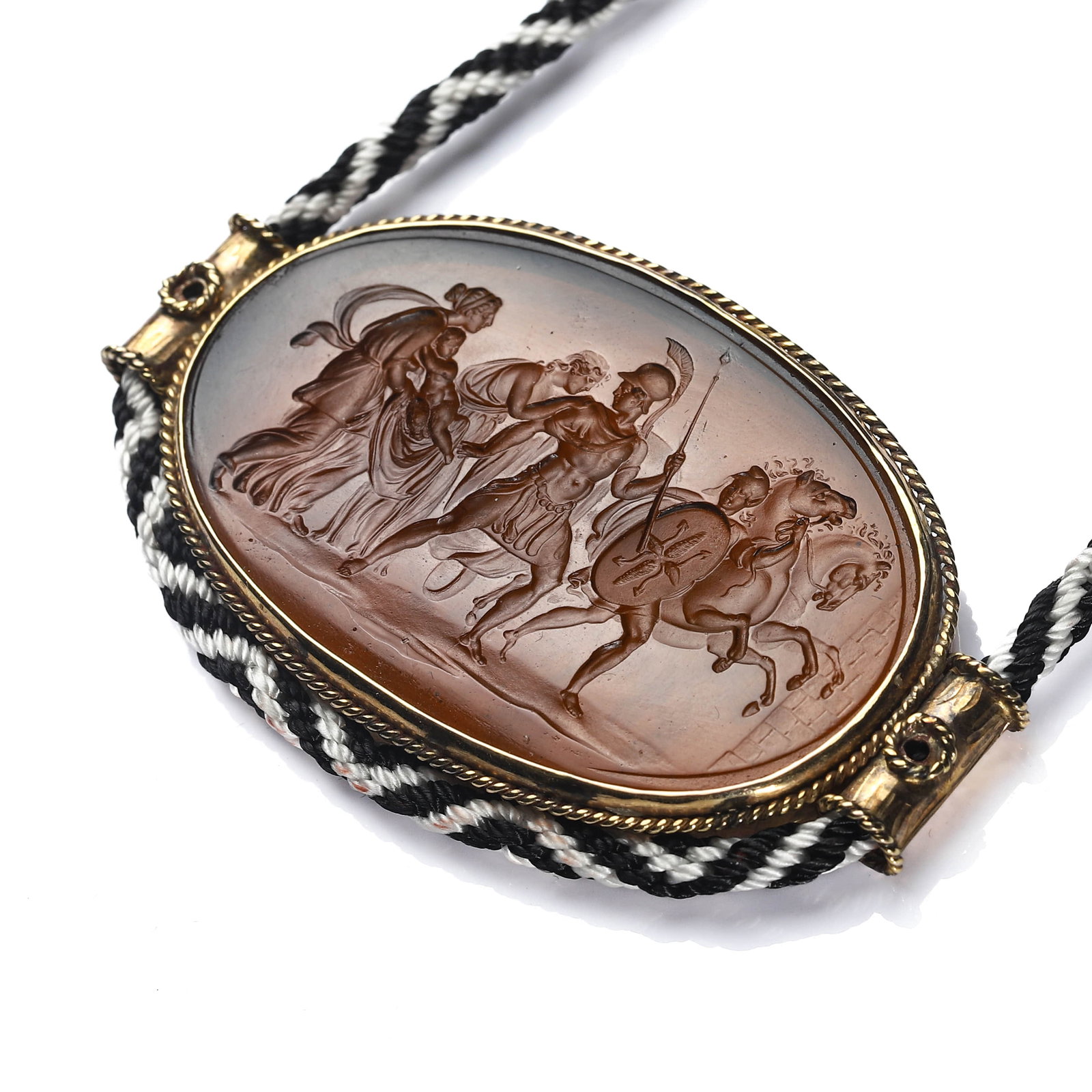 A VICTORIAN GOLD AND GLASS INTAGLIO PENDANT NECKLACE IN THE CLASSICAL GREEK TASTE: Dimensions Pendant 2 11/16 x 1 1/2 in. (6.8 x 3.8 cm)Weight: 28.1 g (excluding cord) Description A Victorian period (1837-1901) pendant necklace, finely handcrafted in 11K gold and centered with a
