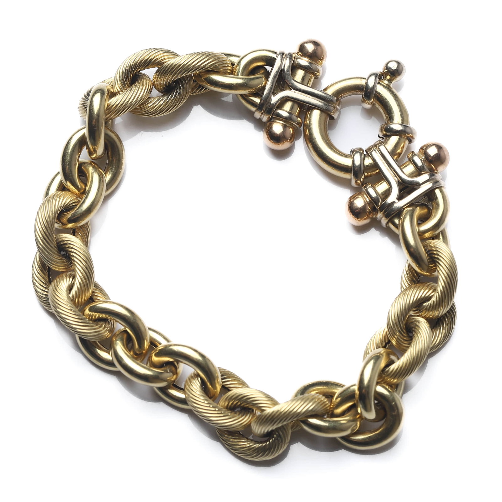 AN ITALIAN 18K GOLD AND CARNELIAN BRACELET: Dimensions length approx.7 11/16 in (19.5 cm); weight approx. 23.12 g. Description A stylish Italian bracelet composed of polished oval-link elements in a contrasting two-tone design, featuring white 